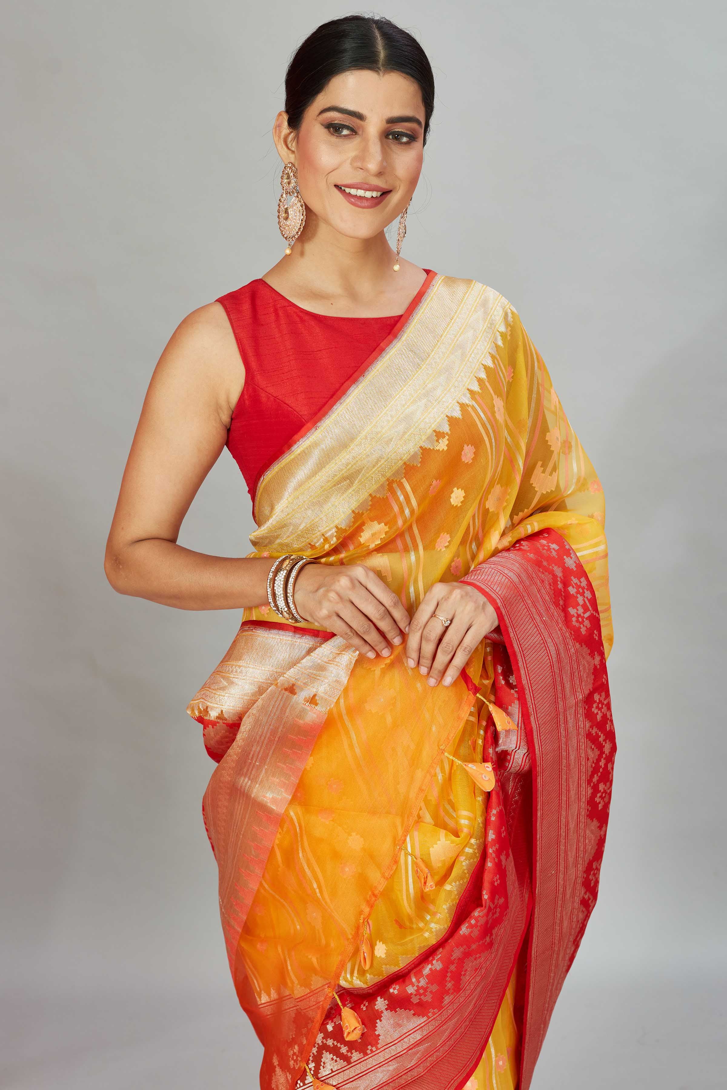 Buy yellow Kora Banarasi sari online in USA with red zari border. Look your best on festive occasions in latest designer sarees, pure silk sarees, Kanjivaram silk saris, handwoven saris, tussar silk sarees, embroidered saris from Pure Elegance Indian clothing store in USA.-closeup