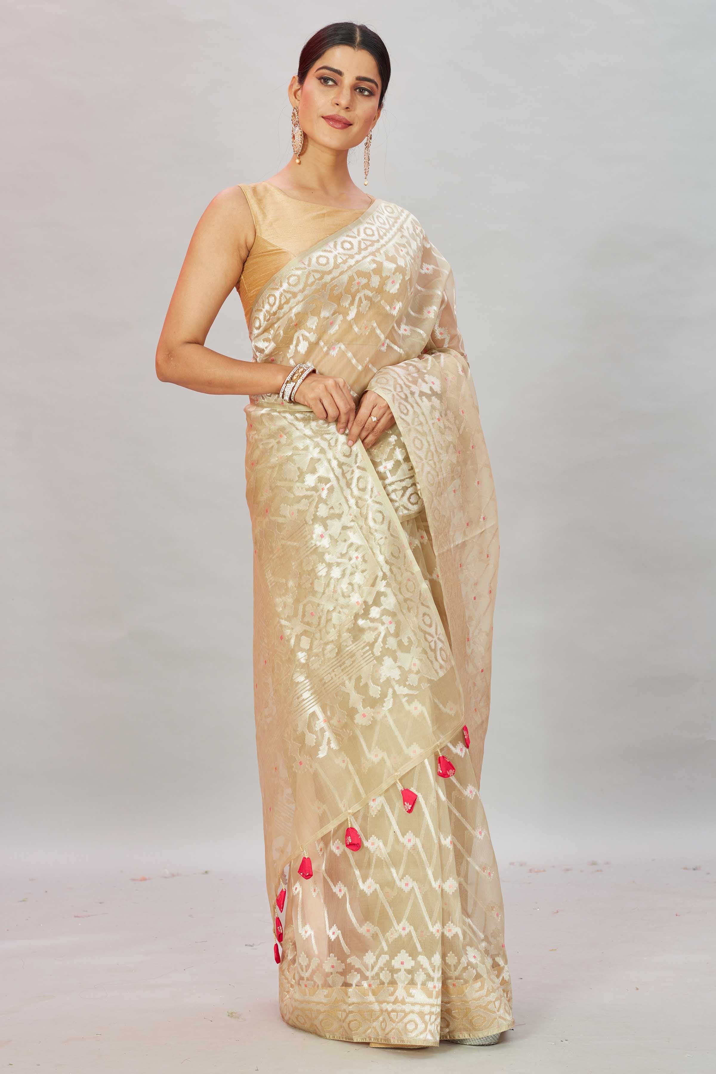 Buy cream Kora Banarasi sari online in USA with overall zari work. Look your best on festive occasions in latest designer sarees, pure silk sarees, Kanjivaram silk saris, handwoven saris, tussar silk sarees, embroidered saris from Pure Elegance Indian clothing store in USA.-saree