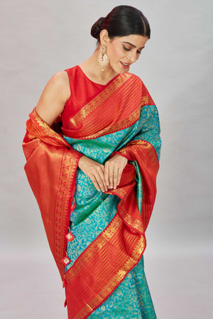 Buy sea green floral Kanjivaram silk saree online in USA with red zari stripes border. Look your best on festive occasions in latest designer sarees, pure silk sarees, Kanjivaram silk saris, handwoven saris, tussar silk sarees, embroidered saris from Pure Elegance Indian clothing store in USA.-closeup