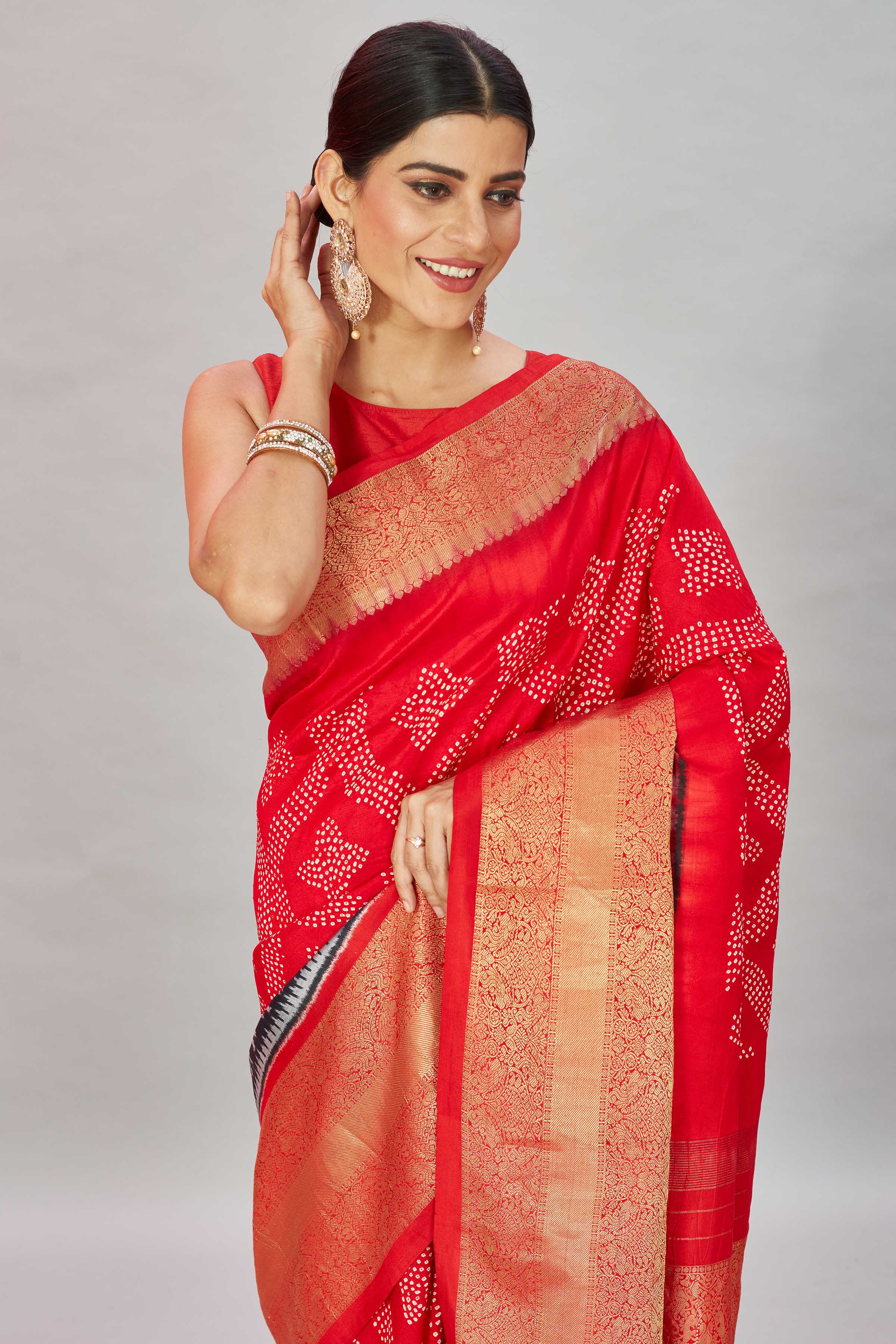 Buy red bandhej Kanjivaram silk saree online in USA with ikkat border. Look your best on festive occasions in latest designer sarees, pure silk sarees, Kanjivaram silk saris, handwoven saris, tussar silk sarees, embroidered saris from Pure Elegance Indian clothing store in USA.-closeup