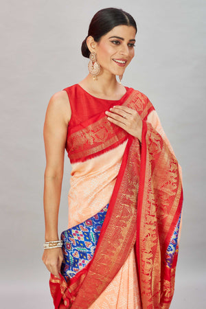 Shop peach bandhej Kanjivaram silk saree online in USA with blue ikkat border. Look your best on festive occasions in latest designer sarees, pure silk sarees, Kanjivaram silk saris, handwoven saris, tussar silk sarees, embroidered saris from Pure Elegance Indian clothing store in USA.-closeup