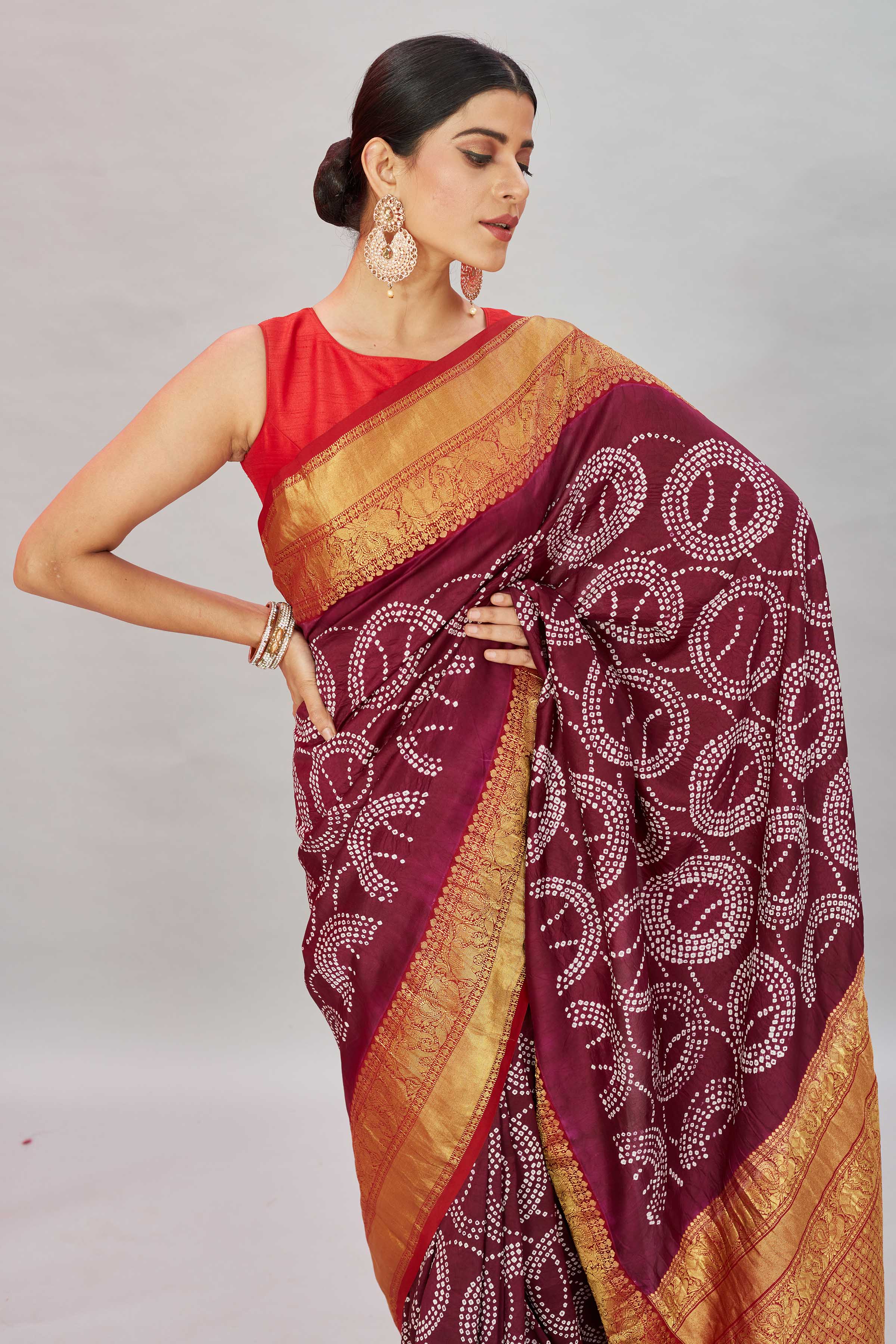 Buy wine color bandhej Kanjivaram silk sari online in USA with zari border. Look your best on festive occasions in latest designer sarees, pure silk sarees, Kanjivaram silk saris, handwoven saris, tussar silk sarees, embroidered saris from Pure Elegance Indian clothing store in USA.-closeup