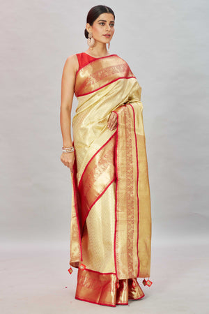 Buy cream Kanjivaram silk sari online in USA with red zari border. Look your best on festive occasions in latest designer sarees, pure silk sarees, Kanjivaram silk saris, handwoven saris, tussar silk sarees, embroidered saris from Pure Elegance Indian clothing store in USA.-side
