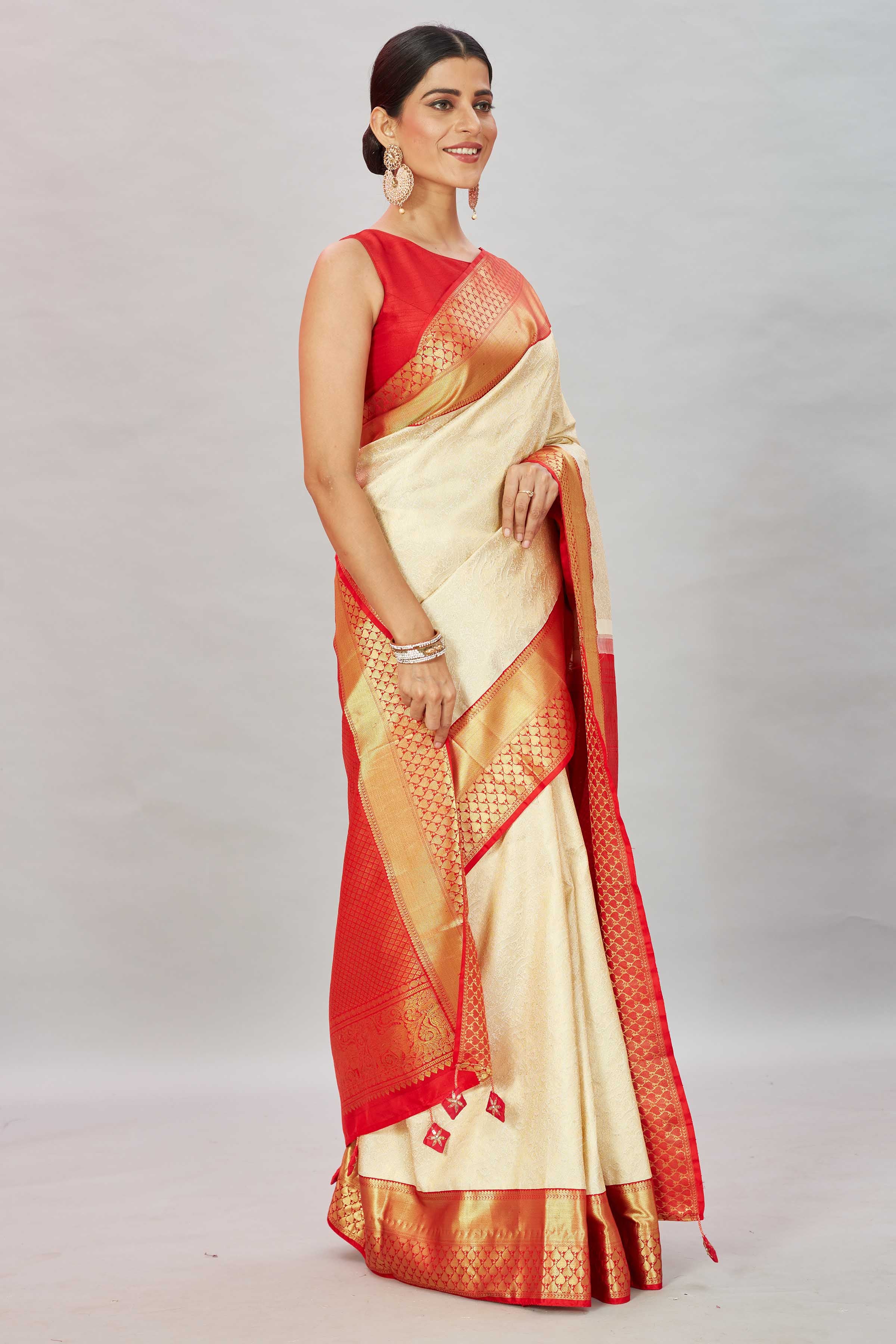 Shop cream Kanjivaram silk saree online in USA with red zari border. Look your best on festive occasions in latest designer sarees, pure silk sarees, Kanjivaram silk saris, handwoven saris, tussar silk sarees, embroidered saris from Pure Elegance Indian clothing store in USA.-side