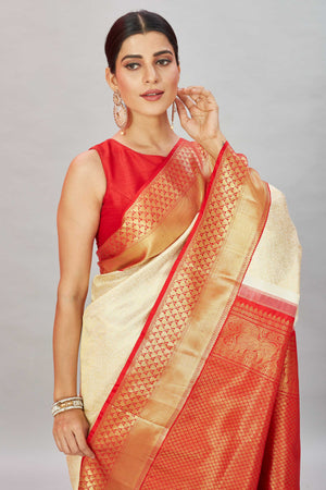 Shop cream Kanjivaram silk saree online in USA with red zari border. Look your best on festive occasions in latest designer sarees, pure silk sarees, Kanjivaram silk saris, handwoven saris, tussar silk sarees, embroidered saris from Pure Elegance Indian clothing store in USA.-closeup