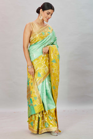 Buy pastel green Kanjivaram silk sari online in USA with yellow floral border. Look your best on festive occasions in latest designer sarees, pure silk sarees, Kanjivaram silk saris, handwoven saris, tussar silk sarees, embroidered saris from Pure Elegance Indian clothing store in USA.-side