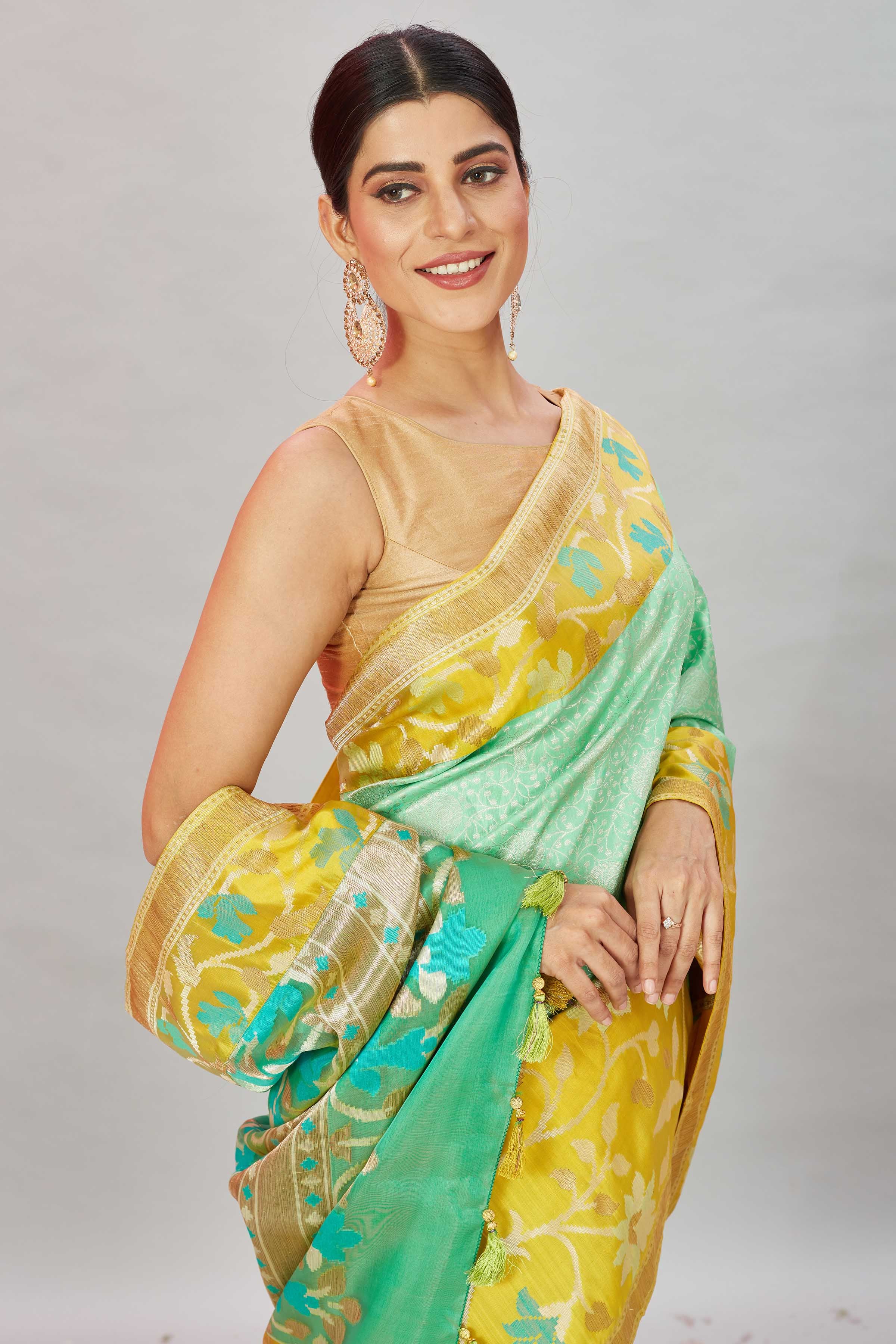 Buy pastel green Kanjivaram silk sari online in USA with yellow floral border. Look your best on festive occasions in latest designer sarees, pure silk sarees, Kanjivaram silk saris, handwoven saris, tussar silk sarees, embroidered saris from Pure Elegance Indian clothing store in USA.-closeup