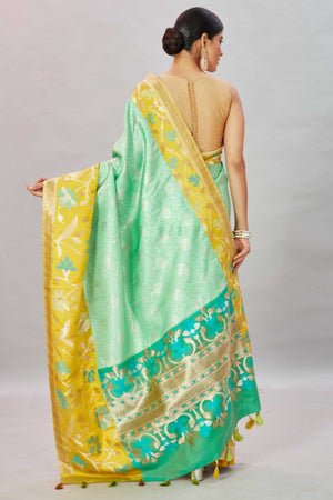 Buy pastel green Kanjivaram silk sari online in USA with yellow floral border. Look your best on festive occasions in latest designer sarees, pure silk sarees, Kanjivaram silk saris, handwoven saris, tussar silk sarees, embroidered saris from Pure Elegance Indian clothing store in USA.-back