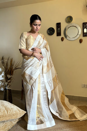 Buy cream and golden chanderi saree online in USA with golden blouse. Look your best on festive occasions in latest designer saris, pure silk saris, Kanjivaram silk sarees, handwoven saris, tussar silk sarees, linen sarees,  summer sarees from Pure Elegance Indian clothing store in USA.-pleats