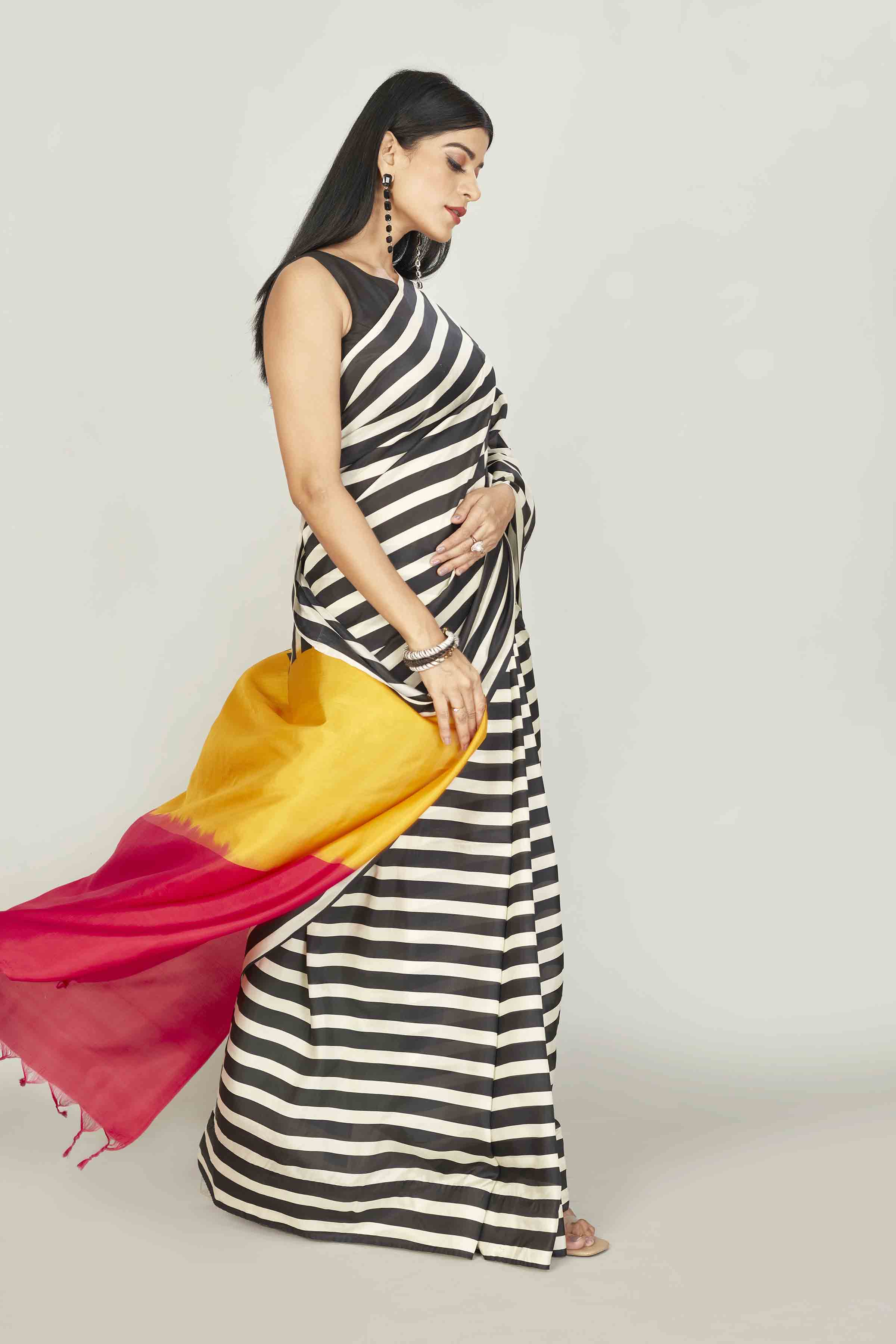 Buy white and black striped silk sari online in USA with yellow red pallu. Look your best on festive occasions in latest designer saris, pure silk saris, tissue silk sarees, handwoven saris, tussar silk sarees, linen sarees,  summer sarees from Pure Elegance Indian clothing store in USA.-side