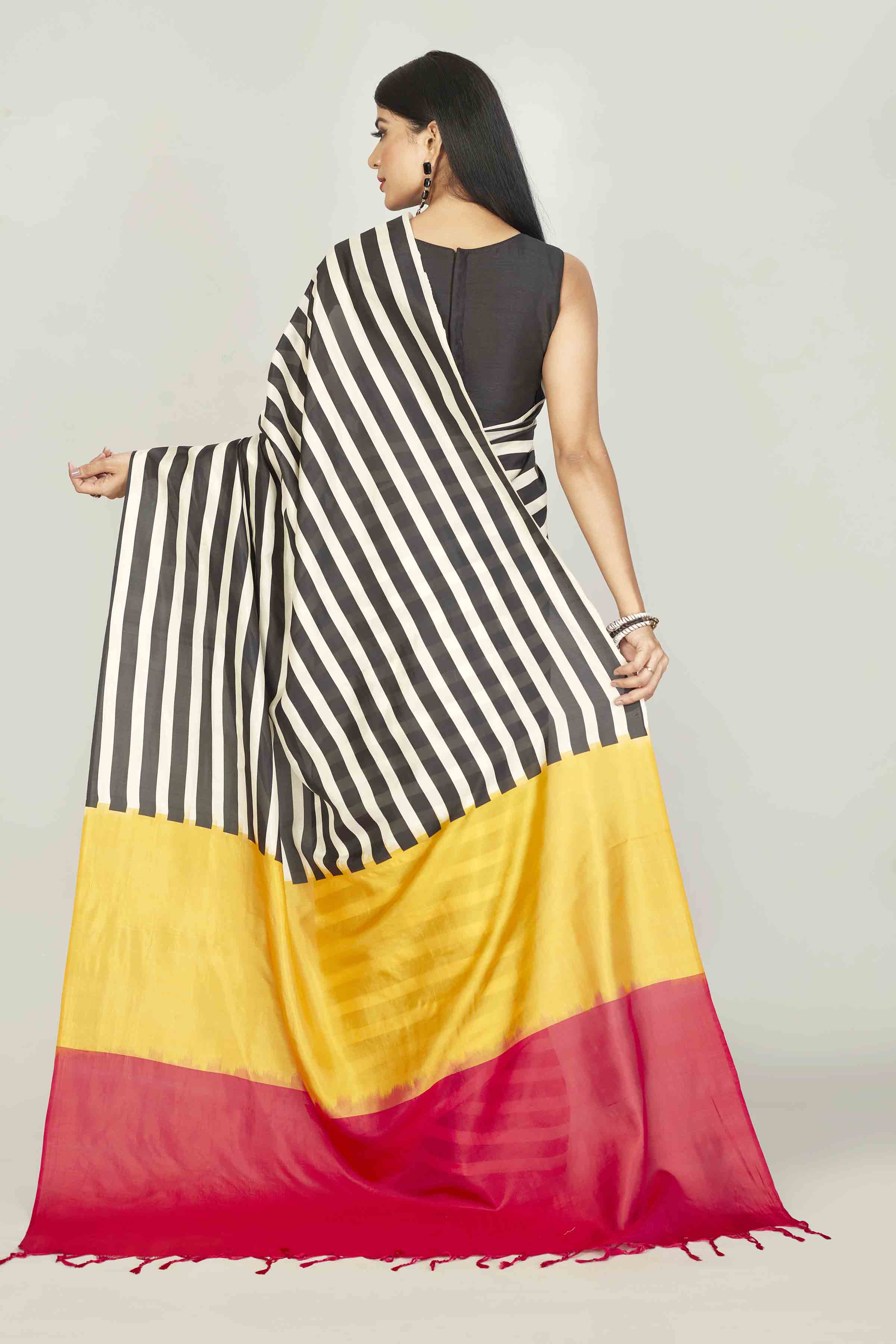 Buy white and black striped silk sari online in USA with yellow red pallu. Look your best on festive occasions in latest designer saris, pure silk saris, tissue silk sarees, handwoven saris, tussar silk sarees, linen sarees,  summer sarees from Pure Elegance Indian clothing store in USA.-back