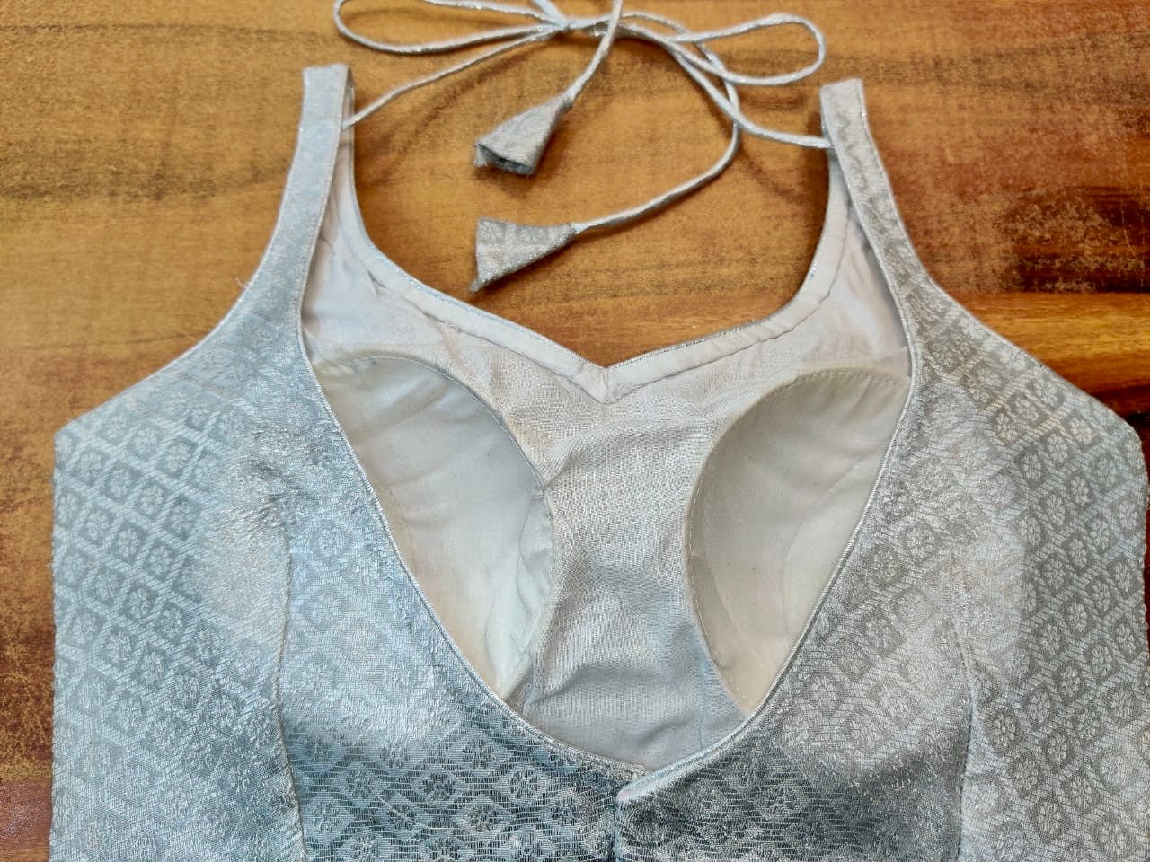 Buy stunning silver Banarasi sleevelss saree blouse online in USA. Elevate your ethnic saree style with a tasteful collection of designer saree blouses from Pure Elegance Indian clothing store in USA.-back