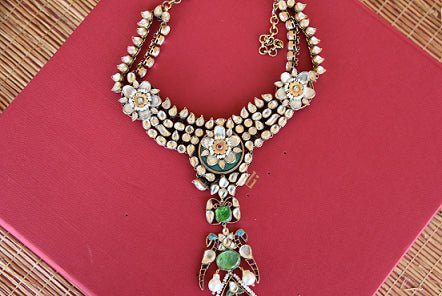 Ethnic as well as classy designer silver gold plated fashion necklace with white and green glass and pearls.-close up