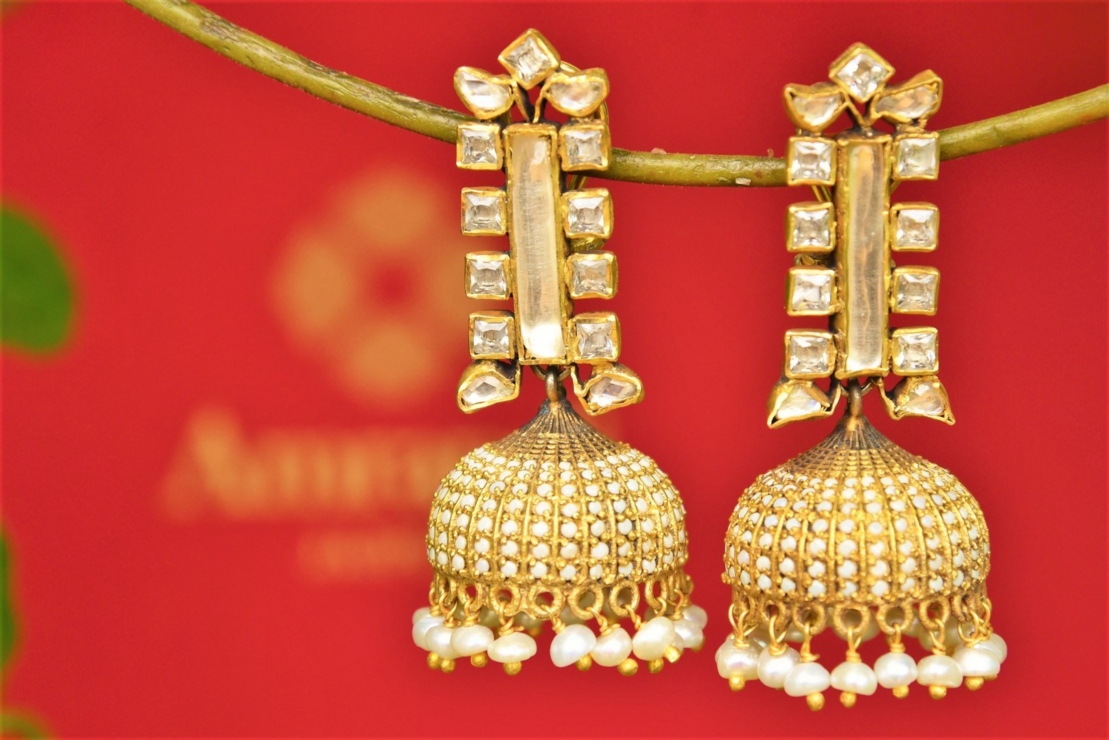 Buy Amrapali silver gold plated zircon and glass jhumka earrings online in USA. Pure Elegance fashion store brings an exquisite range of Indian wedding jewelry in USA.-closeup