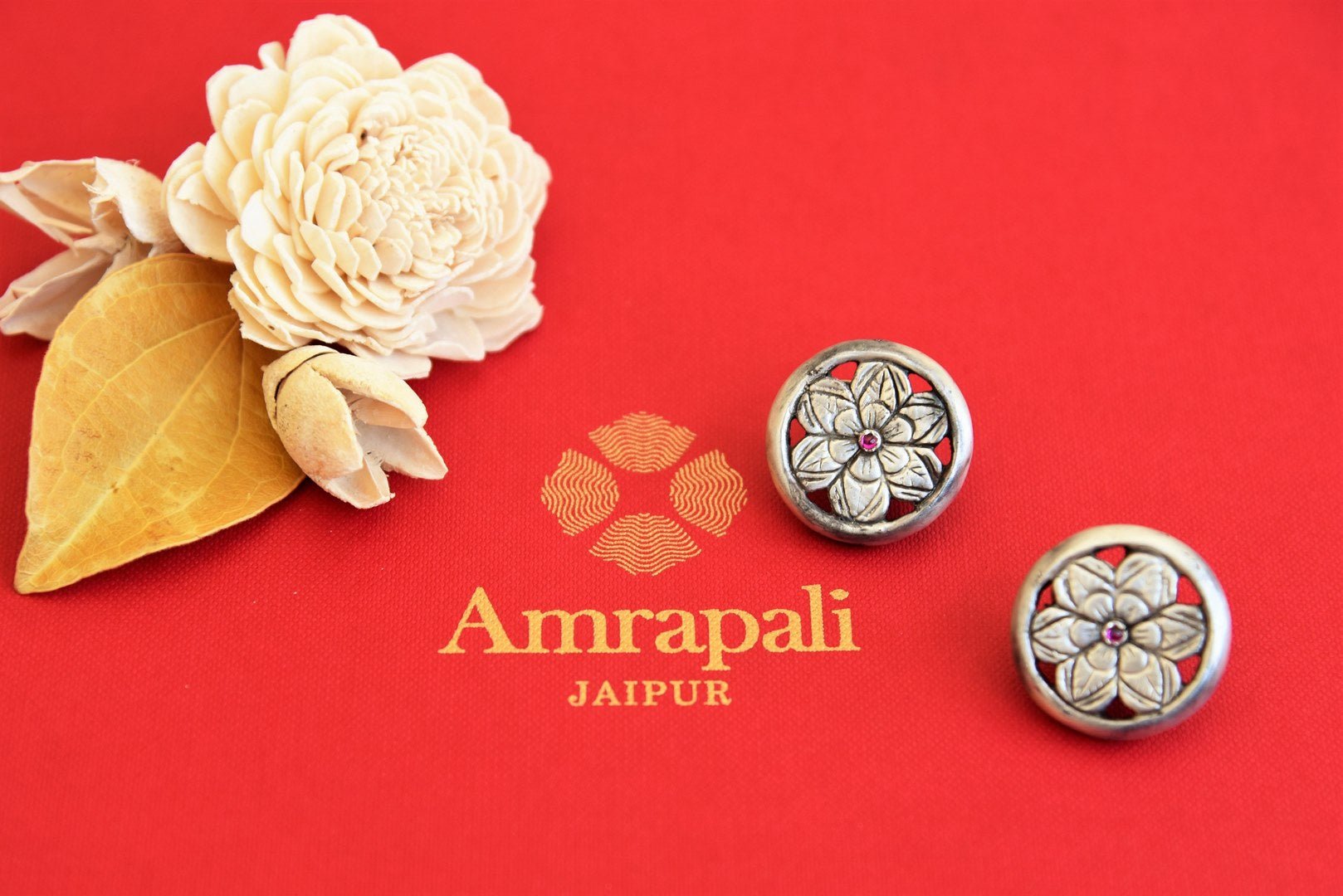 Shop silver flower design stud earrings online in USA by Amrapali. Find an exquisite collection of handcrafted Indian jewellery in USA at Pure Elegance Indian fashion store. Complete your festive look with beautiful silver gold plated necklaces, silver gold plated earrings, silver jewelry from our online store.-flatlay