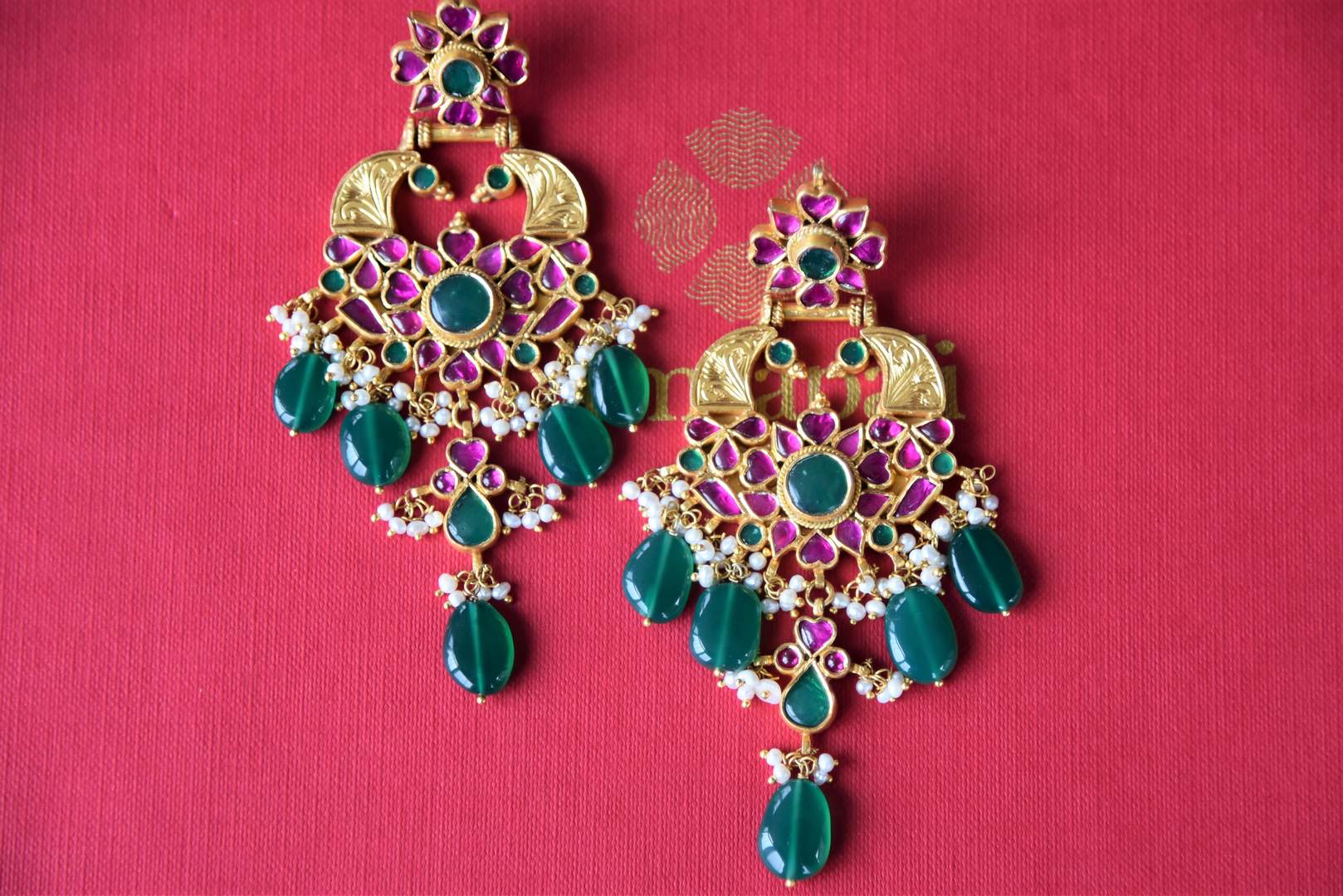 Buy silver gold plated pink glass earrings by Amrapali online in USA with pearls and green stones. Get festival ready with a range of exquisite handcrafted Indian silver gold plated jewelry from Pure Elegance Indian clothing store in USA.-flatlay
