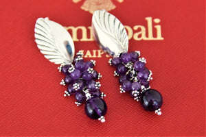 Shop lovely silver leaf earrings online in USA with purple cluster beads. Give yourself a beautiful traditional makeover this wedding season with exquisite gold plated jewellery from Pure Elegance Indian fashion boutique in USA.-flatlay