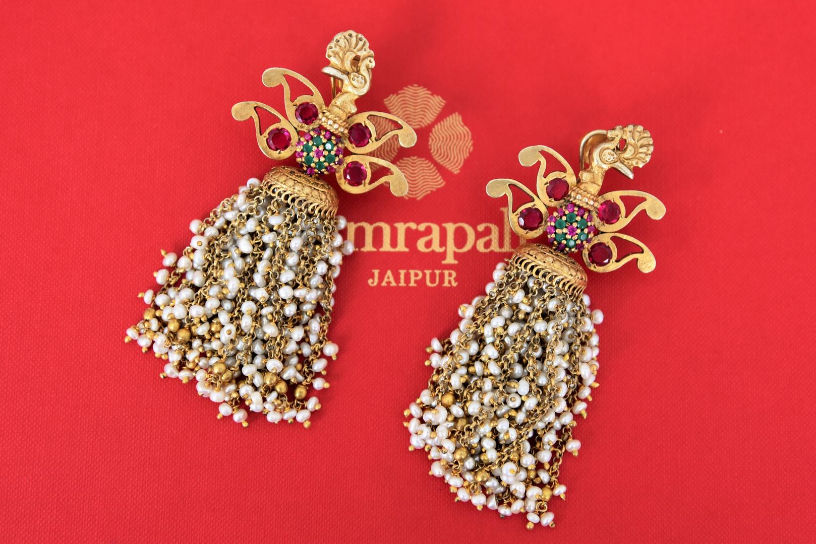 Buy silver gold plated glass peacock earrings online in USA with pearl tassels. Find an exquisite collection of handcrafted Indian jewelry in USA at Pure Elegance Indian fashion store. Complete your festive look with beautiful silver gold plated necklaces, silver gold plated earrings, silver jewelry from our online store.-flatlay