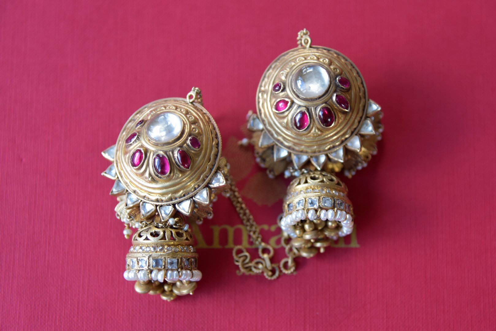 Buy Amrapali silver gold plated white and pink glass jhumki with pearls online in USA. Find an exquisite collection of handcrafted silver gold plated jewelry in USA at Pure Elegance Indian fashion store. Complete your festive look with traditional Indian jewellery, silver gold plated earrings, silver jewelry from our online store.-flatlay