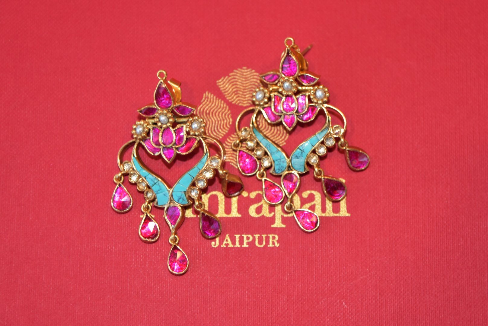 Shop Amrapali silver gold plated pink and turquoise stone earrings online in USA from Pure Elegance. Complete your traditional look with an exquisite collection of Indian silver gold plated jewelry, silver jewelry, silver gold plated earrings and much more from our Indian fashion store in USA. -flatlay