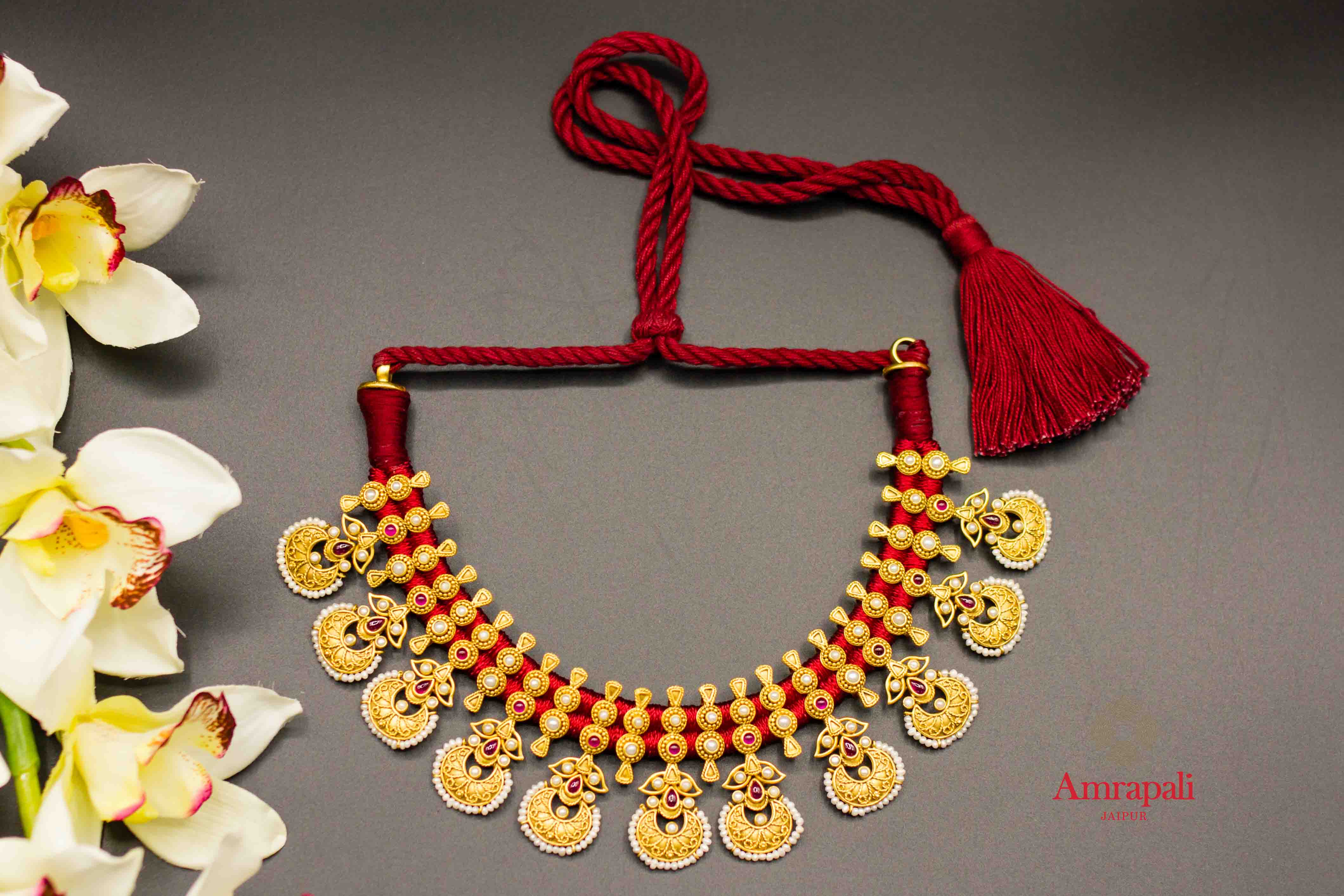 Shop silver gold plated pearl and stone Amrapali thread necklace online in USA. Raise your ethnic style quotient on special occasions with exquisite Indian jewelry from Pure Elegance Indian clothing store in USA. Enhance your Indian look with silver gold plated jewelry, necklaces, silver jewelry available online.-flatlay