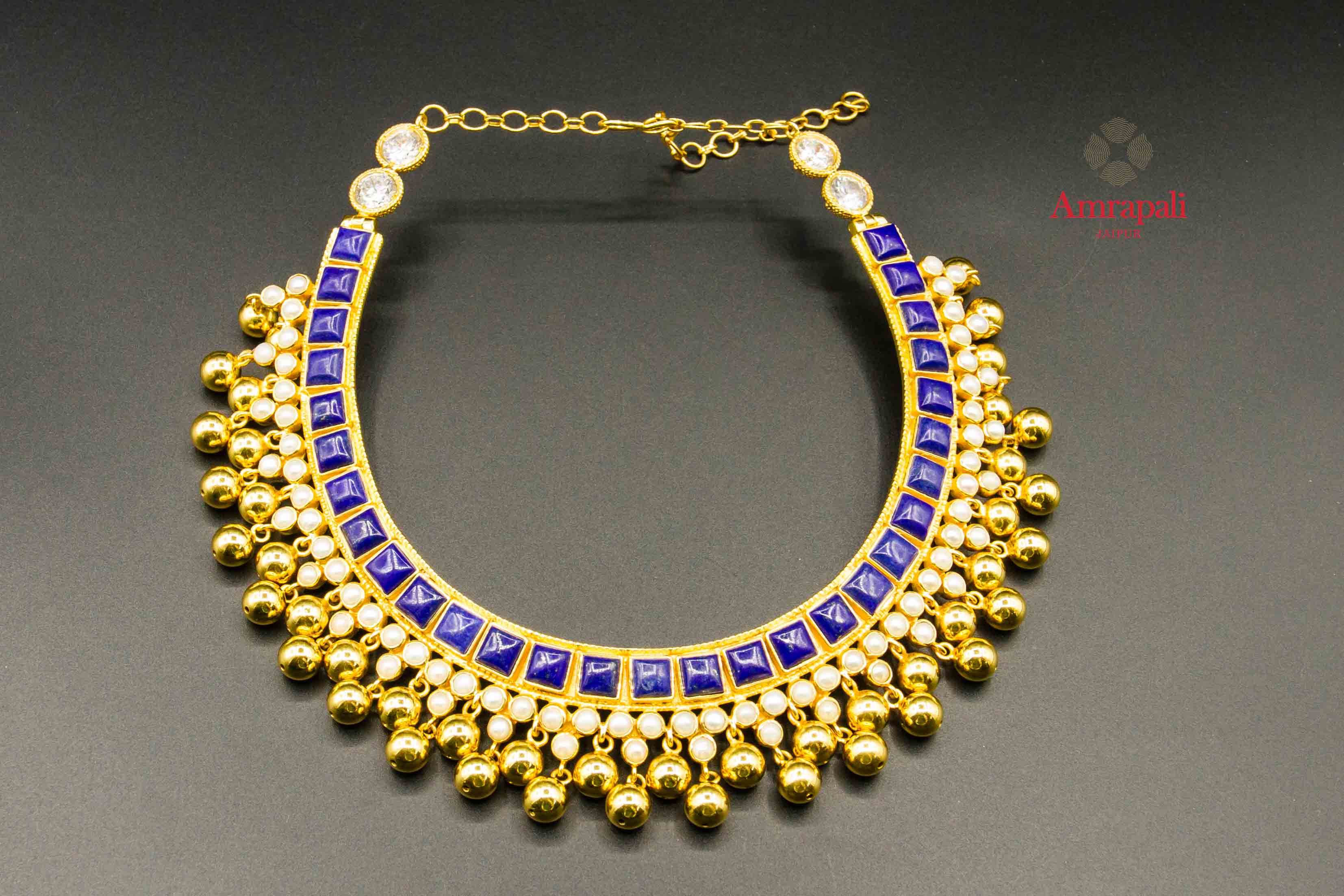 Buy Amrapali silver gold plated pearl and golden beads necklace online in USA with blue stones. Raise your traditional fashion quotient on special occasions with exquisite Indian jewelry from Pure Elegance Indian clothing store in USA. Enhance your look with silver gold plated jewelry, fashion jewelry available online.-flatlay