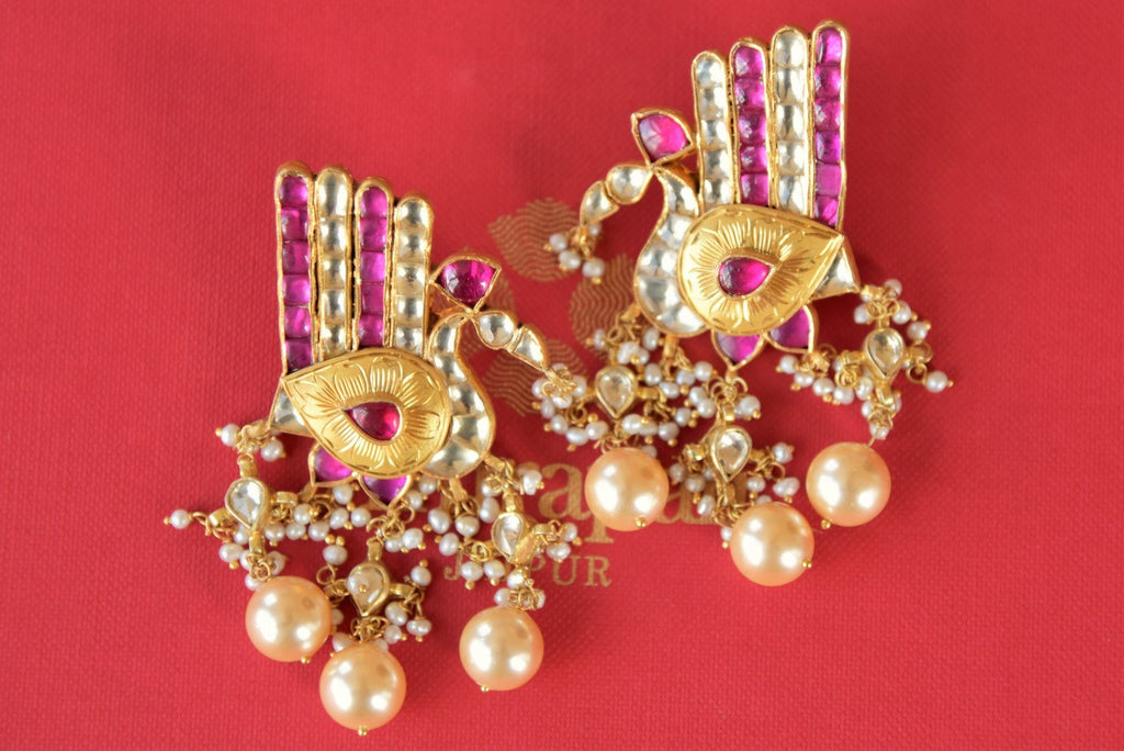 Buy silver gold plated Amrapali red and white glass peacock earrings online in USA. Enhance your ethnic style with exquisite Indian jewelry from Pure Elegance Indian fashion store in USA. Pick from a range of stunning silver gold plated earrings, silver gold plated necklaces, silver jewelry for a perfect finishing...-front