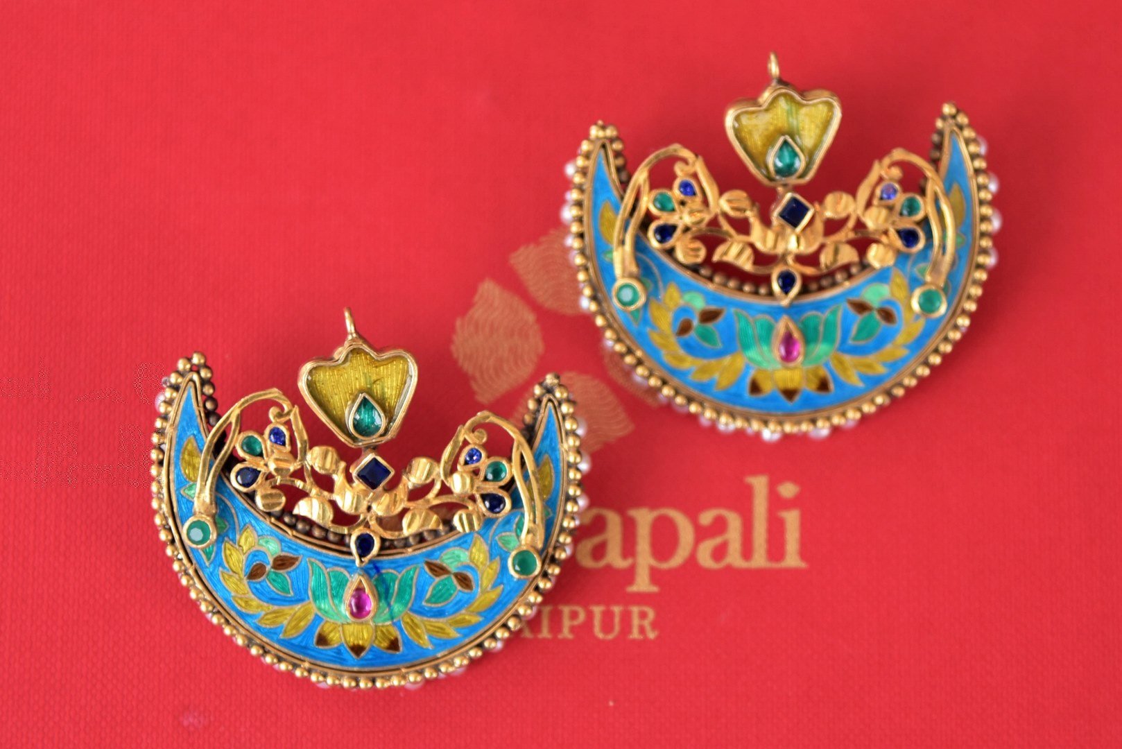 Buy Amrapali blue enamel crescent silver gold plated earrings online in USA. Enhance your ethnic style with exquisite Indian jewelry from Pure Elegance Indian fashion store in USA. Pick from a range of stunning gold plated earrings, silver gold plated necklaces, silver jewelry for a perfect touch to your ethnic style.-front