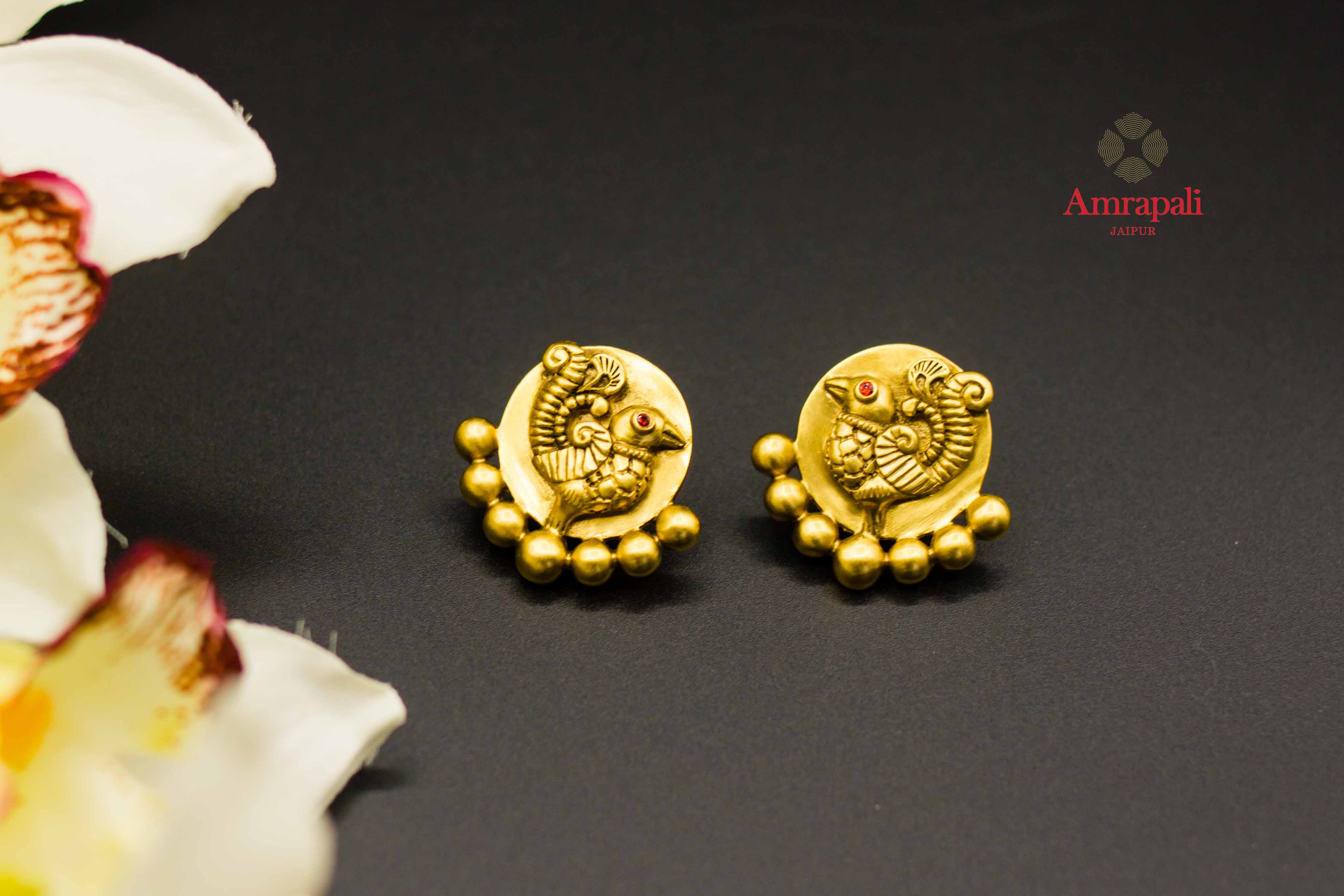Buy Amrapali peacock design silver gold plated stud earrings online in USA. Raise your ethnic style quotient on special occasions with exquisite Indian jewelry from Pure Elegance Indian clothing store in USA. Enhance your Indian look with silver gold plated jewelry, necklaces, fashion jewelry available online.-flatlay