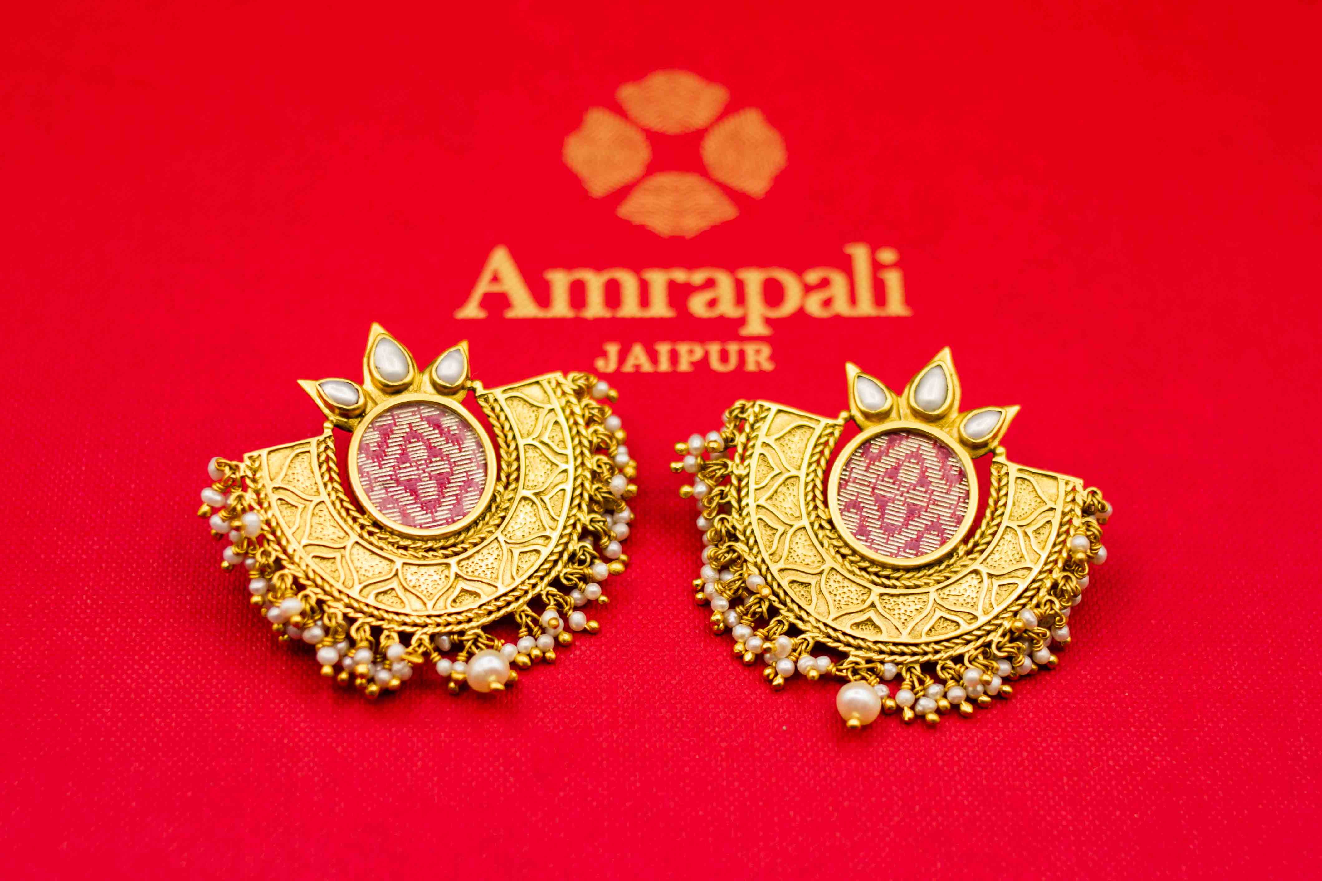 Shop Amrapali silver gold plated crescent shape earrings online in USA with pearls. Raise your ethnic style quotient on special occasions with exquisite Indian jewelry from Pure Elegance Indian clothing store in USA. Enhance your Indian look with silver gold plated jewelry, necklaces, fashion jewelry available online.-flatlay