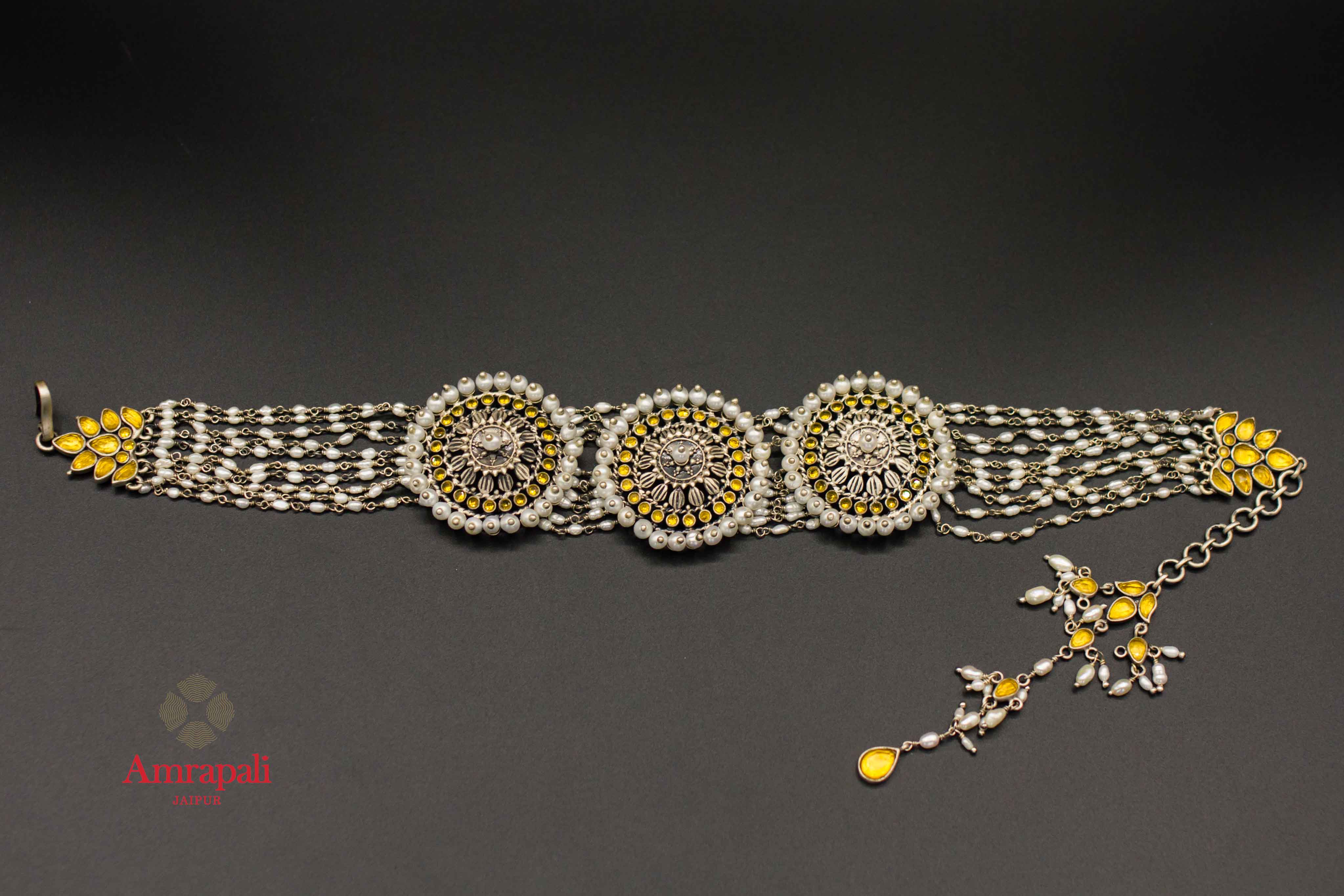 Shop Amrapali silver gold plated pearl chakra choker necklace online in USA. Raise your ethnic style quotient on special occasions with exquisite Indian jewelry from Pure Elegance Indian clothing store in USA. Enhance your Indian look with silver gold plated jewelry, necklaces, fashion jewelry available online.-flatlay