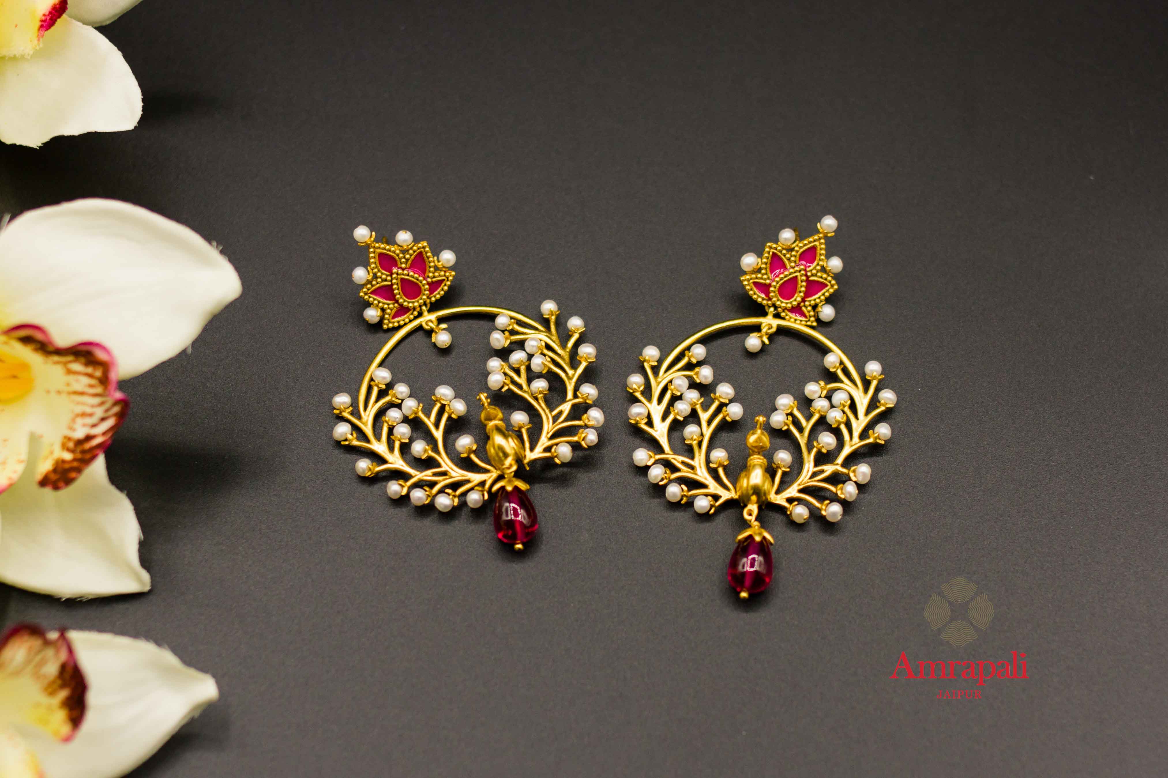 Buy Amrapali silver gold plated pearl peacock hoop earrings online in USA. Raise your ethnic style quotient on special occasions with exquisite Indian jewelry from Pure Elegance Indian clothing store in USA. Enhance your Indian look with silver gold plated jewelry, necklaces, fashion jewelry available online.-flatlay