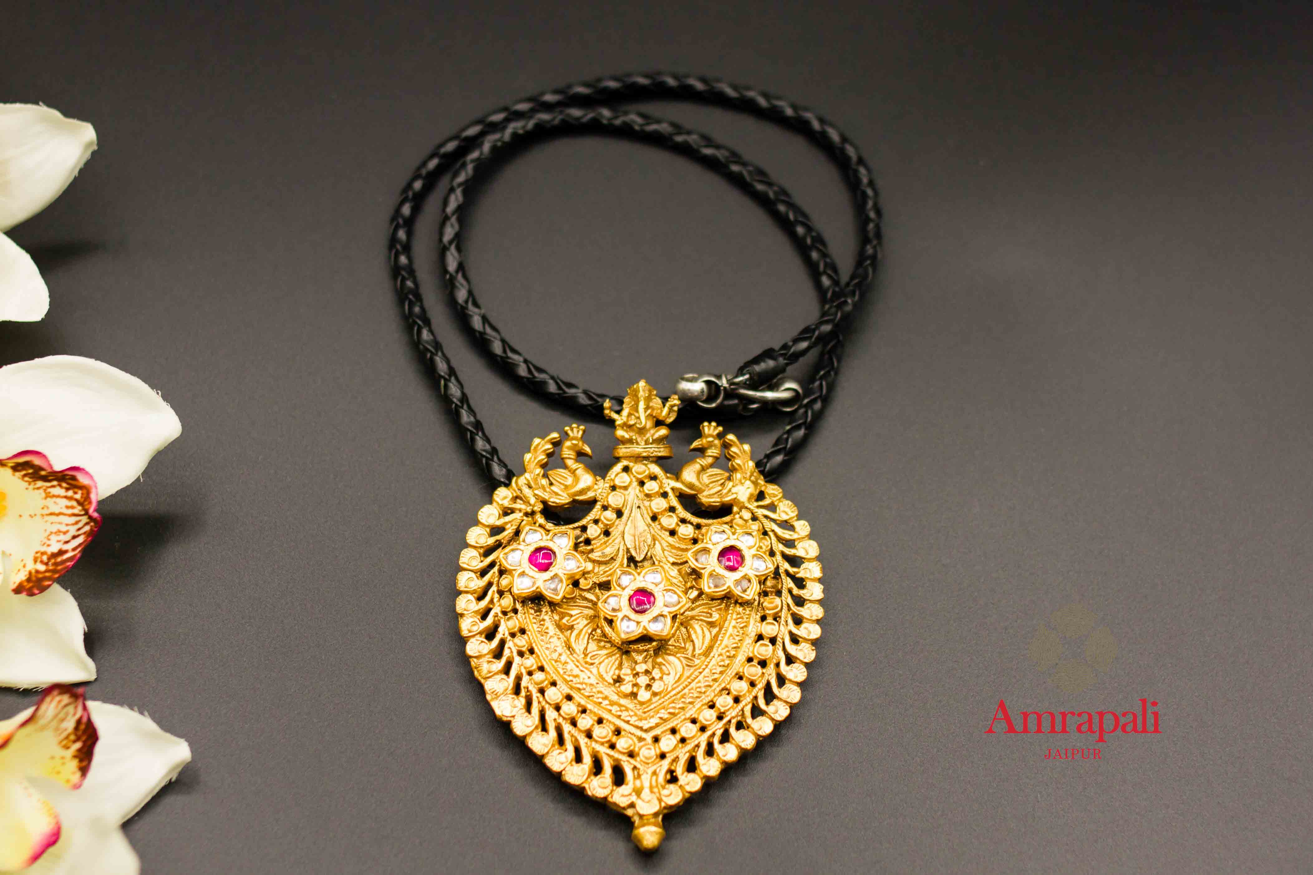 Buy Amrapali silver gold plated Ganesha peacock glass pendant necklace online in USA. Raise your ethnic style quotient on special occasions with exquisite Indian jewelry from Pure Elegance Indian clothing store in USA. Enhance your Indian look with silver gold plated jewelry, fashion jewelry available online.-flatlay