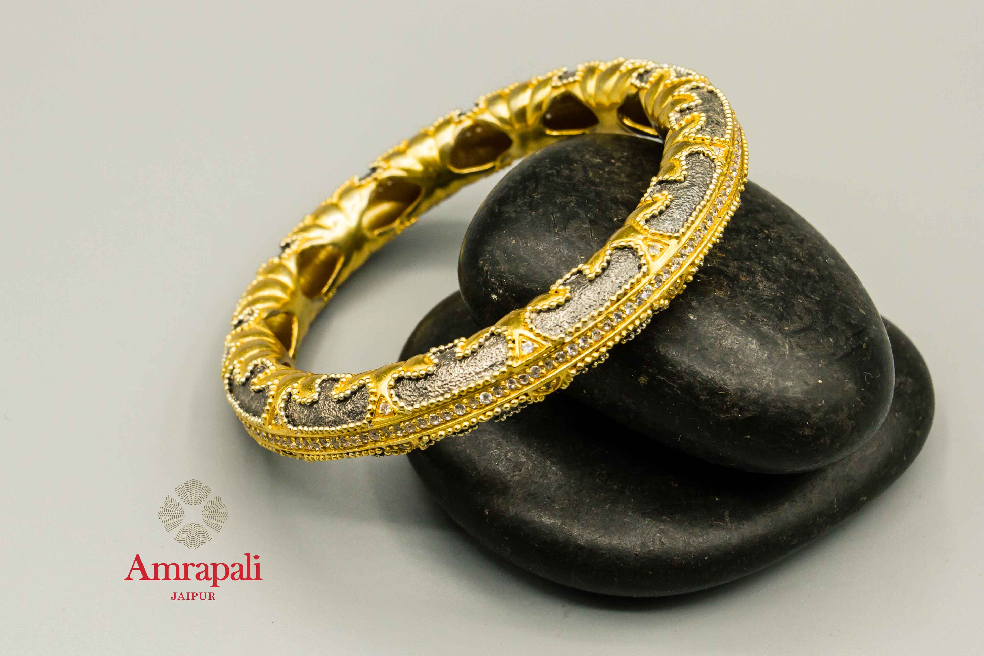 Buy Amrapali silver gold plated two-tone textured bangle online in USA. Raise your traditional fashion quotient on special occasions with exquisite Indian jewelry from Pure Elegance Indian clothing store in USA. Enhance your look with silver gold plated jewelry, wedding jewellery available online.-flatlay
