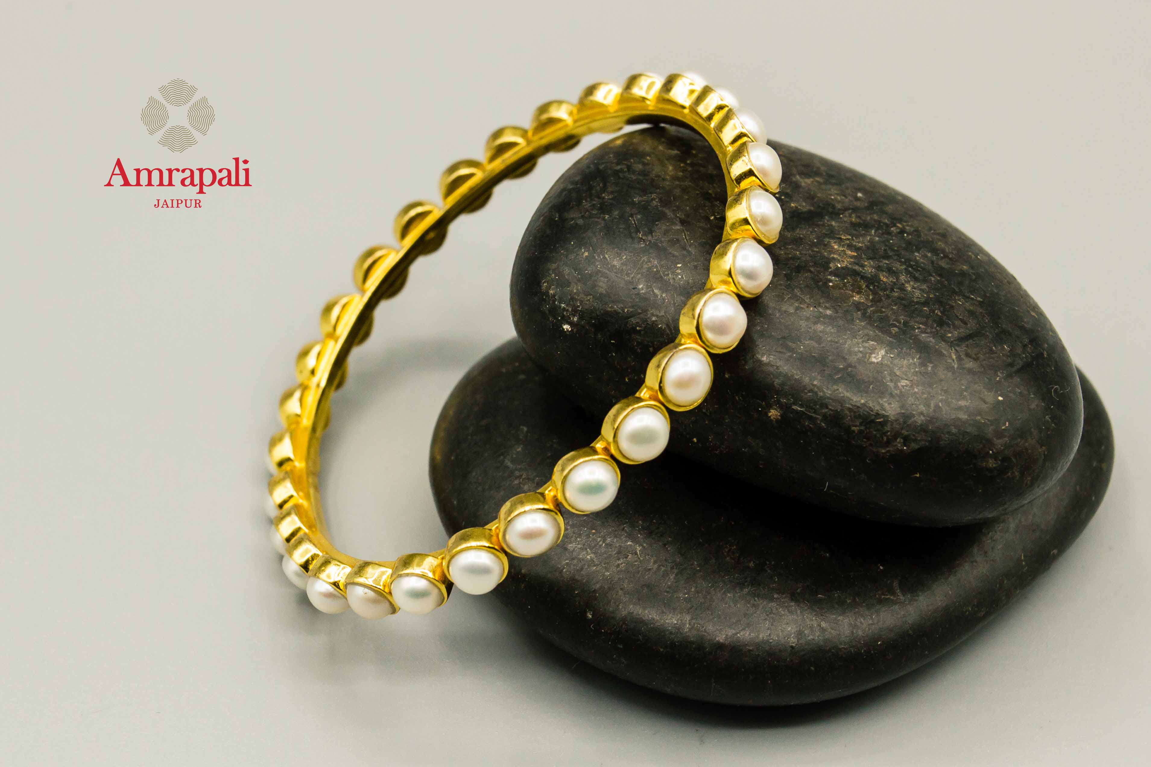 Shop Amrapali pearl silver gold plated bangle online in USA. Raise your traditional fashion quotient on special occasions with exquisite Amrapali jewelry from Pure Elegance Indian clothing store in USA. Enhance your look with Indian silver gold plated jewelry, wedding jewellery available online.-flatlay