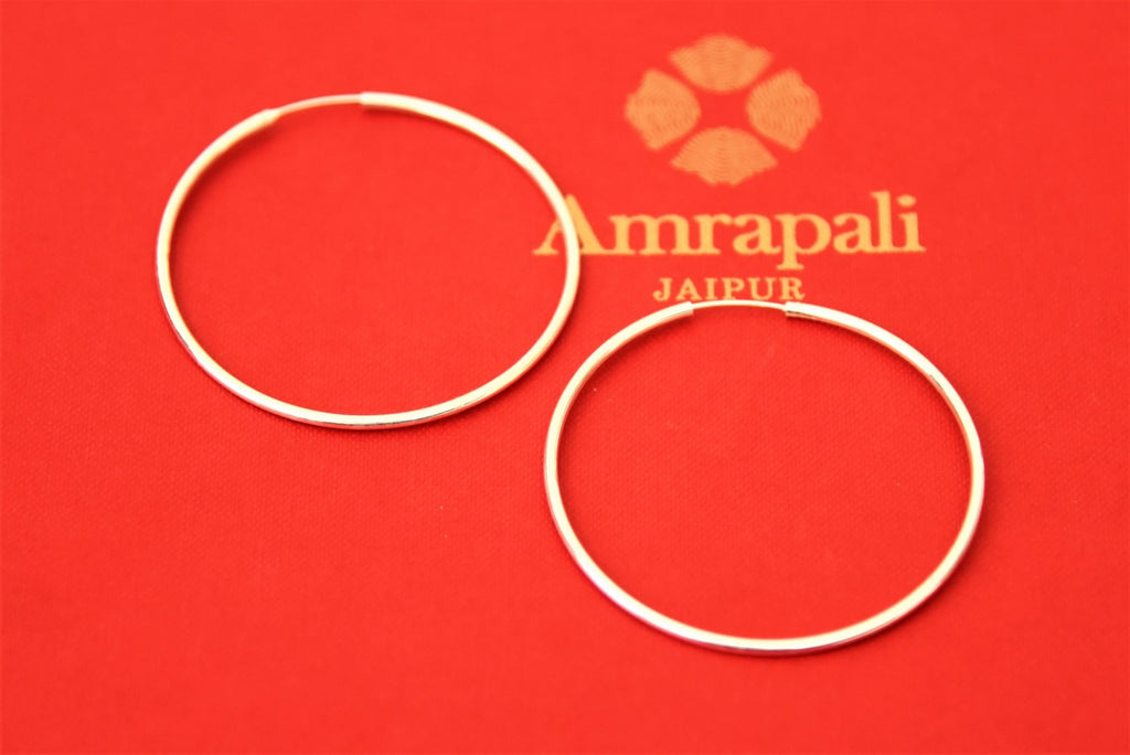 Buy Amrapali classic silver hoop earrings online in USA. Choose from a beautiful range of Indian jewelry, silver jewelry, silver earrings, gold plated jewelry from Pure Elegance Indian fashion store in USA.-flatlay