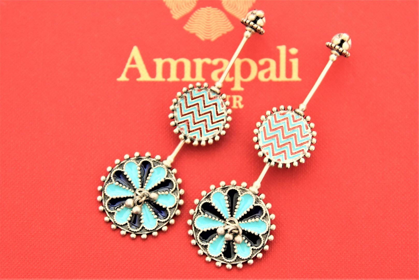 Shop Amrapali enamel contemporary silver earrings online in USA. Enhance your ethnic attires with exquisite Amrapali silver jewelry, silver necklace, silver gold plated jewelry, silver earrings, silver bangles from Pure Elegance Indian fashion store in USA.-flatlay