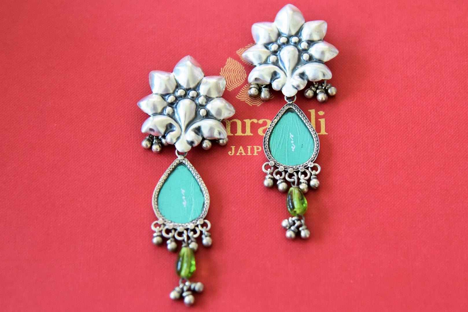 Buy stunning Amrapali blue stone silver flower top earrings online in USA. Complete your festive look with exclusive silver gold plated jewelry, gold plated earrings, silver jewelry, silver earrings from Pure Elegance Indian fashion store in USA.-front