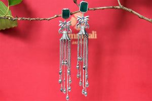 Shop stunning silver tassel earrings online in USA with green stone top. Complete your festive look with exclusive silver gold plated jewelry, gold plated earrings, silver jewelry, silver earrings from Pure Elegance Indian fashion store in USA.-front