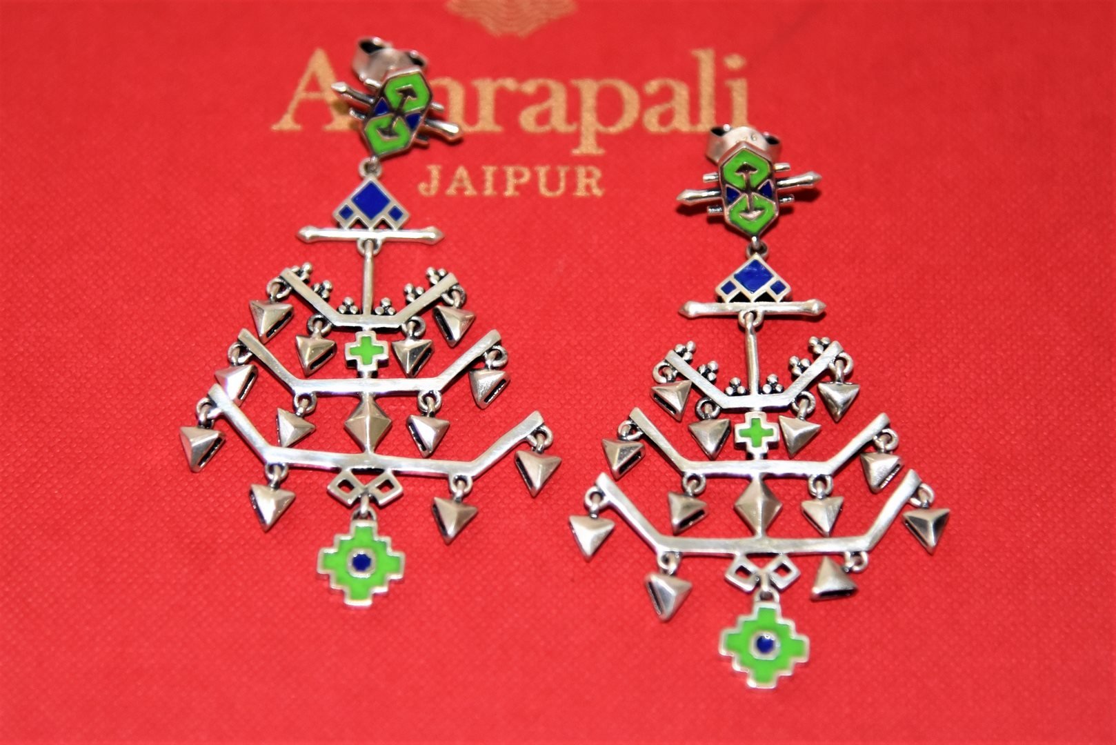 Shop stunning Amrapali green and blue enamel silver earrings online in USA. Complete your festive look with exclusive silver gold plated jewelry, gold plated earrings, silver jewelry, silver earrings from Pure Elegance Indian fashion store in USA.-flatlay