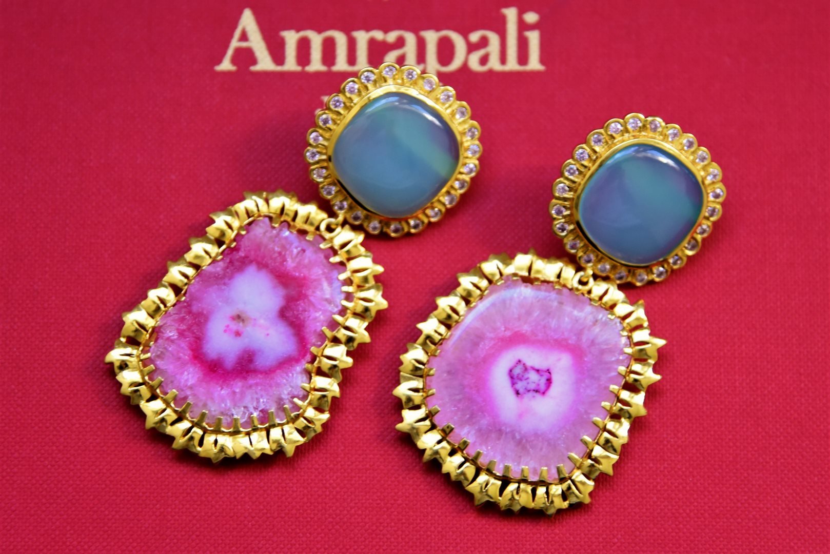 Shop stunning Amrapali pink and blue stone gold plated earrings online in USA. Complete your festive look with exclusive silver gold plated jewelry, gold plated earrings, silver jewelry, silver earrings from Pure Elegance Indian fashion store in USA.-front