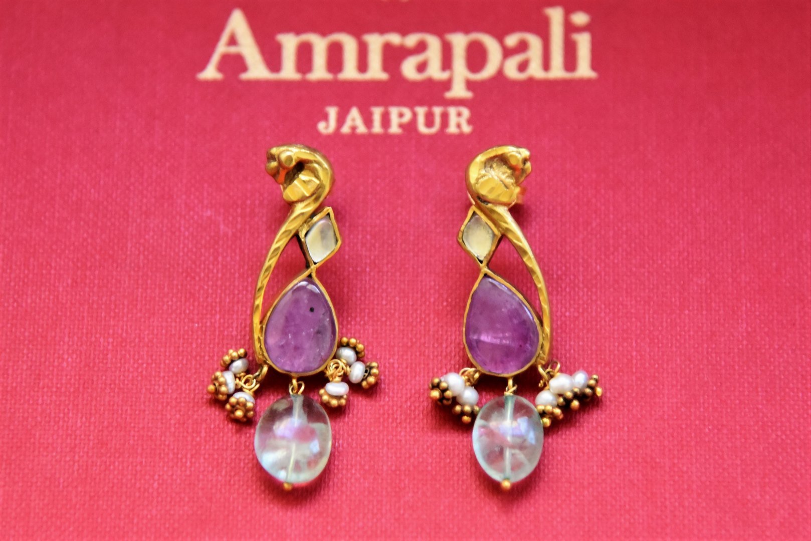 Buy stunning silver gold plated purple stone and glass earrings online in USA. Complete your festive look with exclusive silver gold plated jewelry, gold plated earrings, silver jewelry, silver earrings from Pure Elegance Indian fashion store in USA.-flatlay
