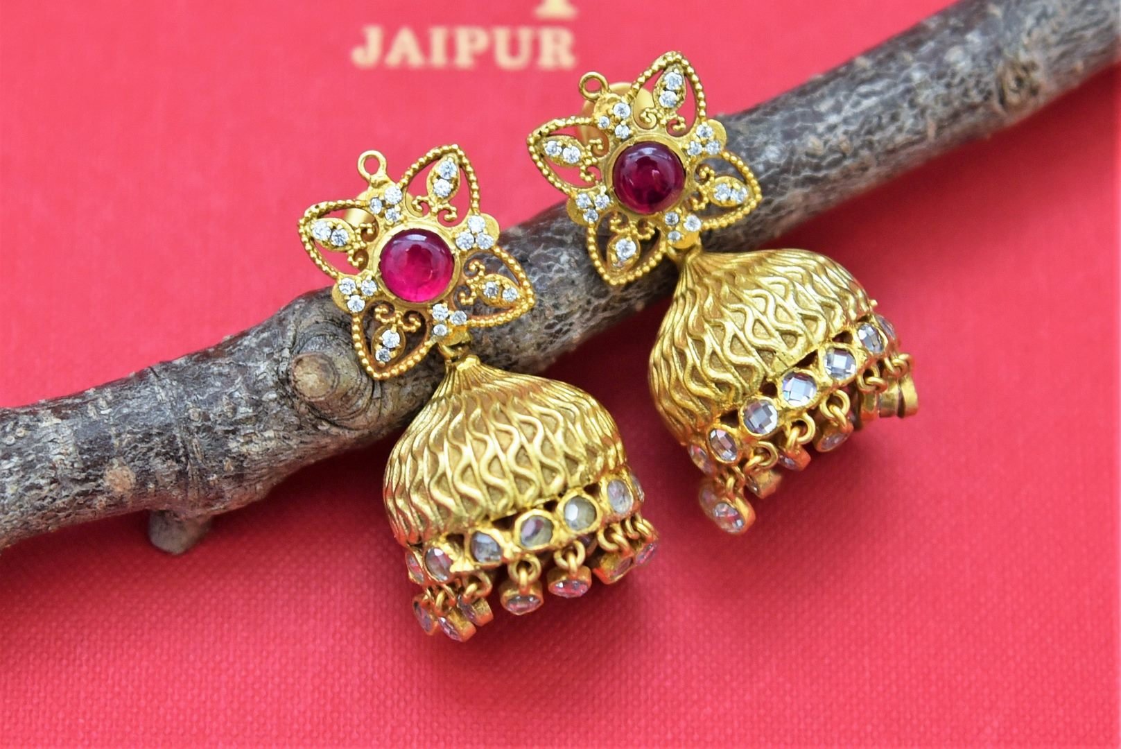 Buy stunning gold plated glass jhumka earrings online in USA. Shop beautiful Amrapali jewelry, gold plated necklaces, silver jewelry, wedding jewelry, gold plated earrings from Pure Elegance Indian fashion store in USA.-front