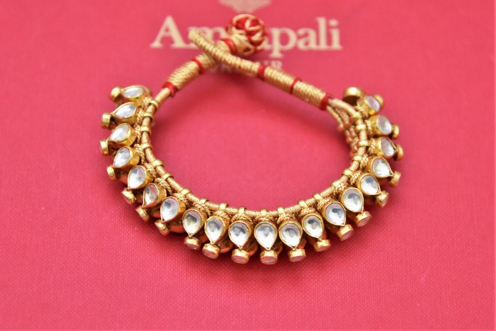 Shop stunning Amrapali gold plated kundan paunchi online in USA. Shop beautiful Amrapali jewelry, gold plated necklaces, silver jewelry, wedding jewelry, gold plated earrings from Pure Elegance Indian fashion store in USA.-front