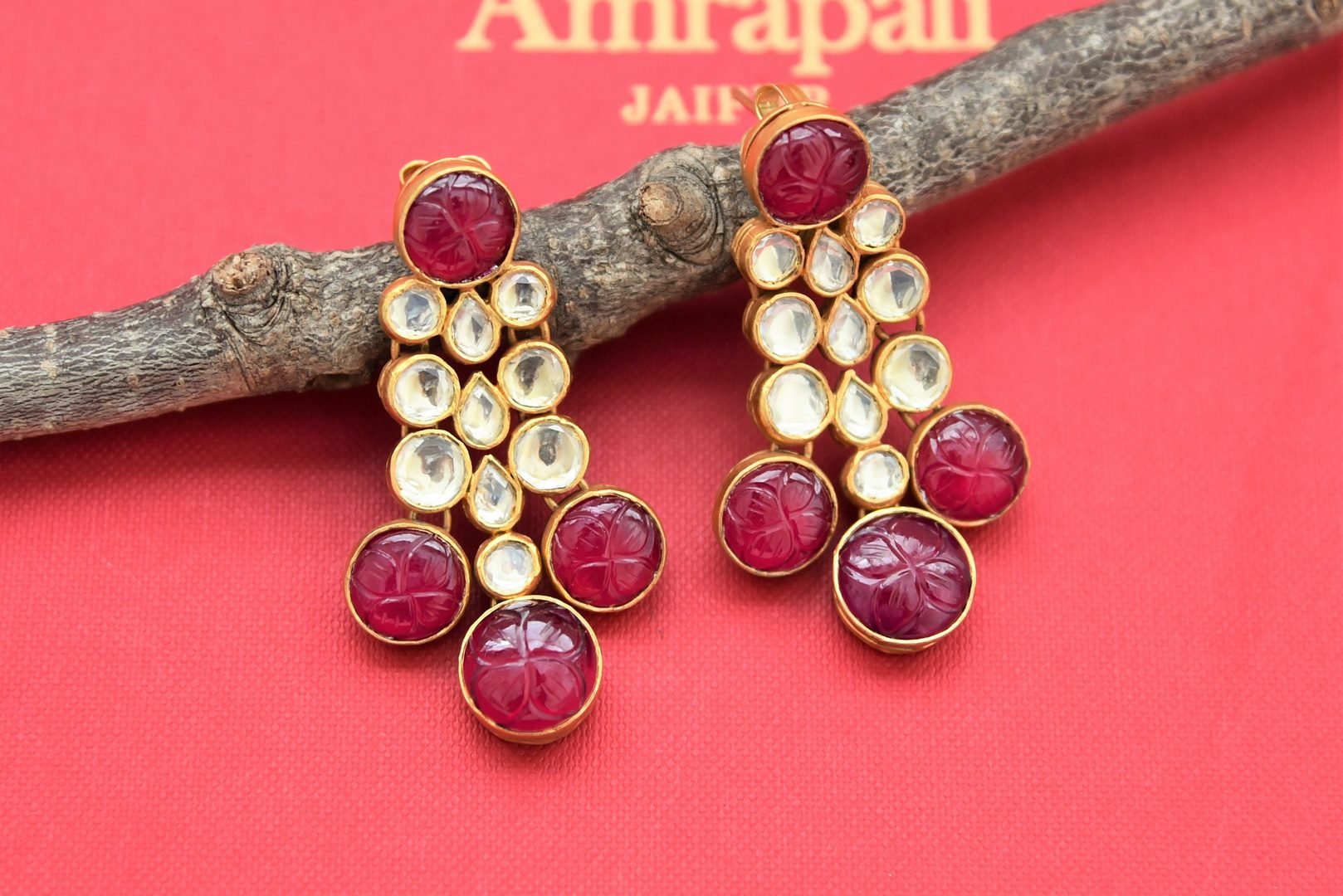 Buy stunning gold plated kundan tassel earrings online in USA with red stones. Shop gold plated jewelry, silver jewelry,  silver earrings, bridal jewelry, fashion jewelry from Amrapali from Pure Elegance Indian clothing store in USA.-full view