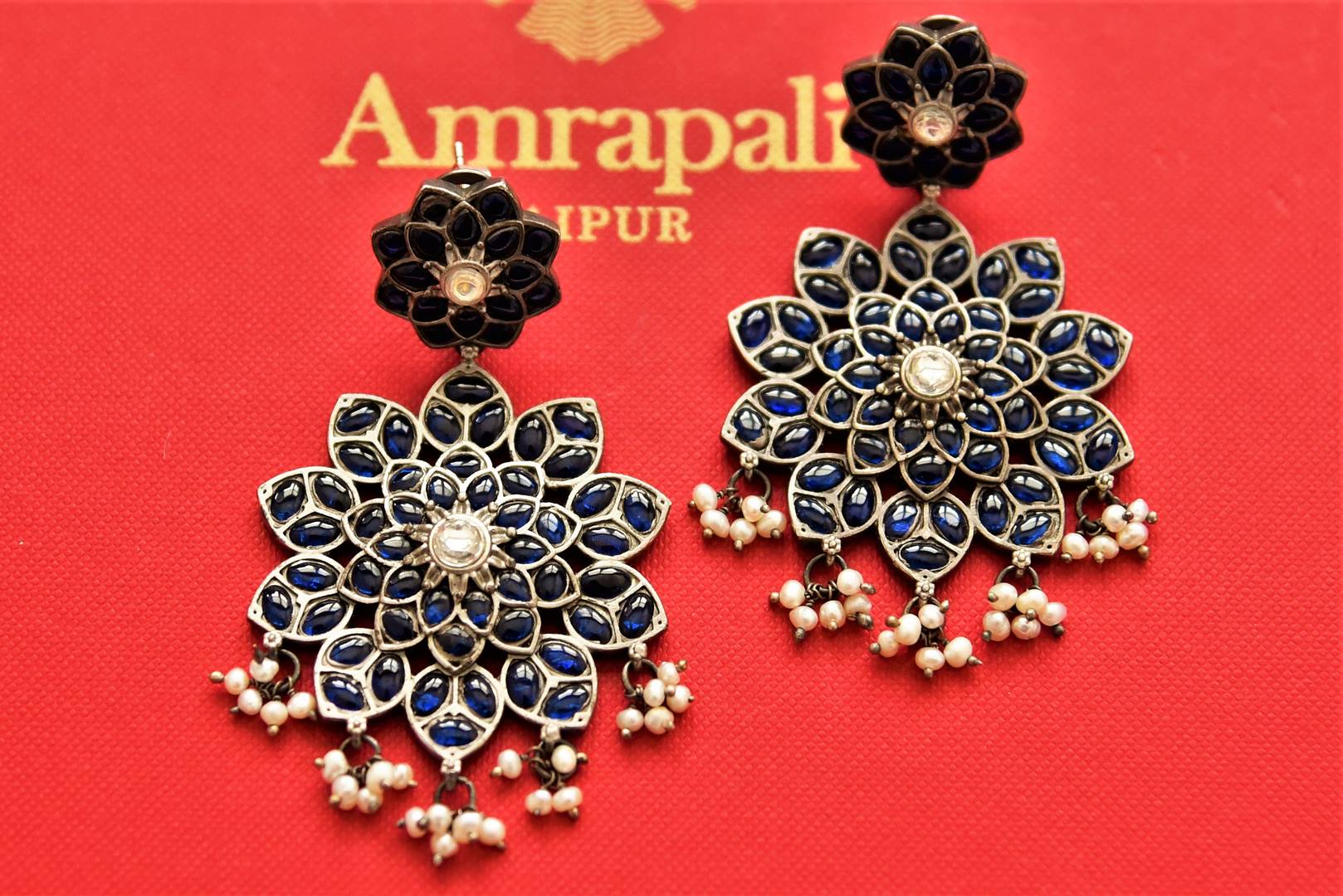 Shop beautiful blue stone floral silver earrings online in USA with pearl drops. Add an elegant touch to your style with gold plated necklace, silver jewelry, wedding jewelry, gold plated earrings in USA from Pure Elegance Indian fashion store in USA.-full view