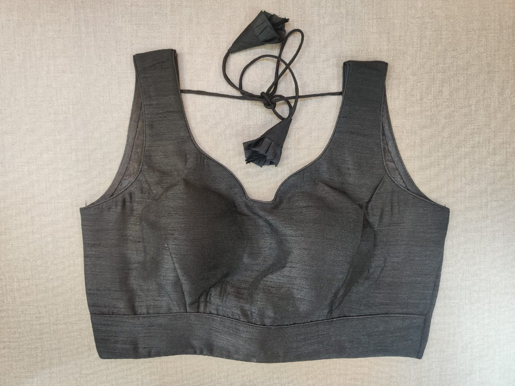 Buy stunning solid black sleeveless saree blouse online in USA. Elevate your Indian ethnic saree looks with beautiful readymade saree blouse, embroidered saree blouses, Banarasi saree blouse, designer sari blouses from Pure Elegance Indian fashion store in USA.-front