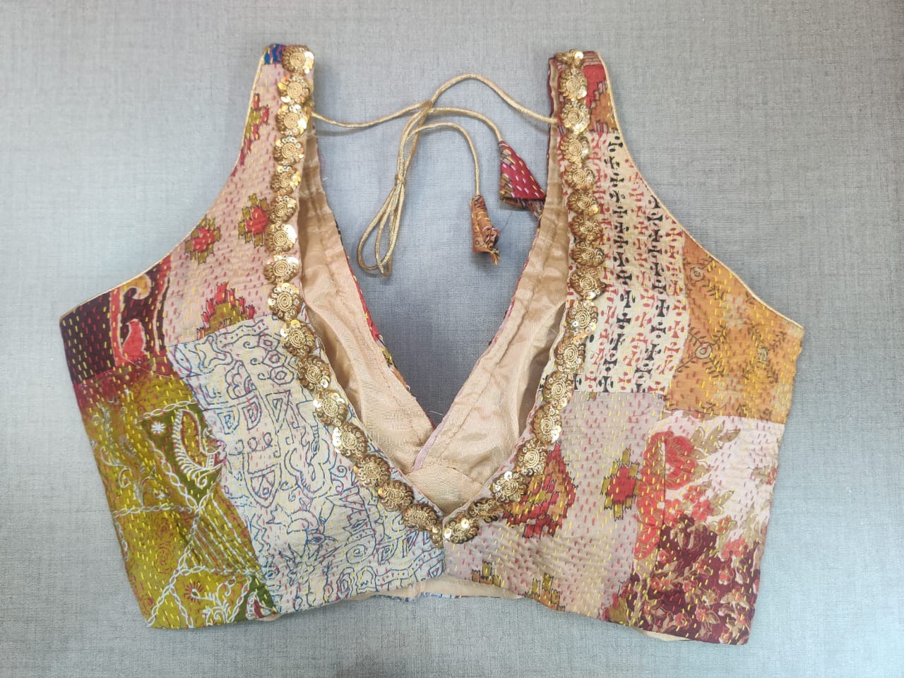 Shop gorgeous multicolor patch Kantha embroidered sleeveless saree blouse online in USA. Elevate your Indian ethnic saree looks with beautiful readymade saree blouse, embroidered sari blouses, Banarasi sari blouse, designer saree blouse from Pure Elegance Indian fashion store in USA.-back