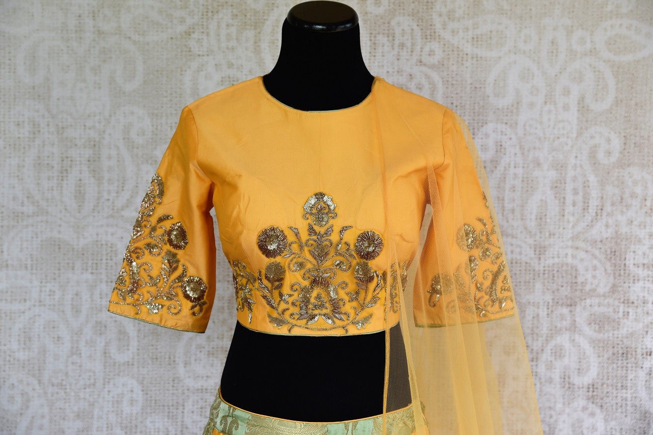 Buy online designer yellow silk and Banarasi embroidered lehenga with blouse and dupatta .  Pure Elegance store brings traditional Indian dresses online in USA.-top