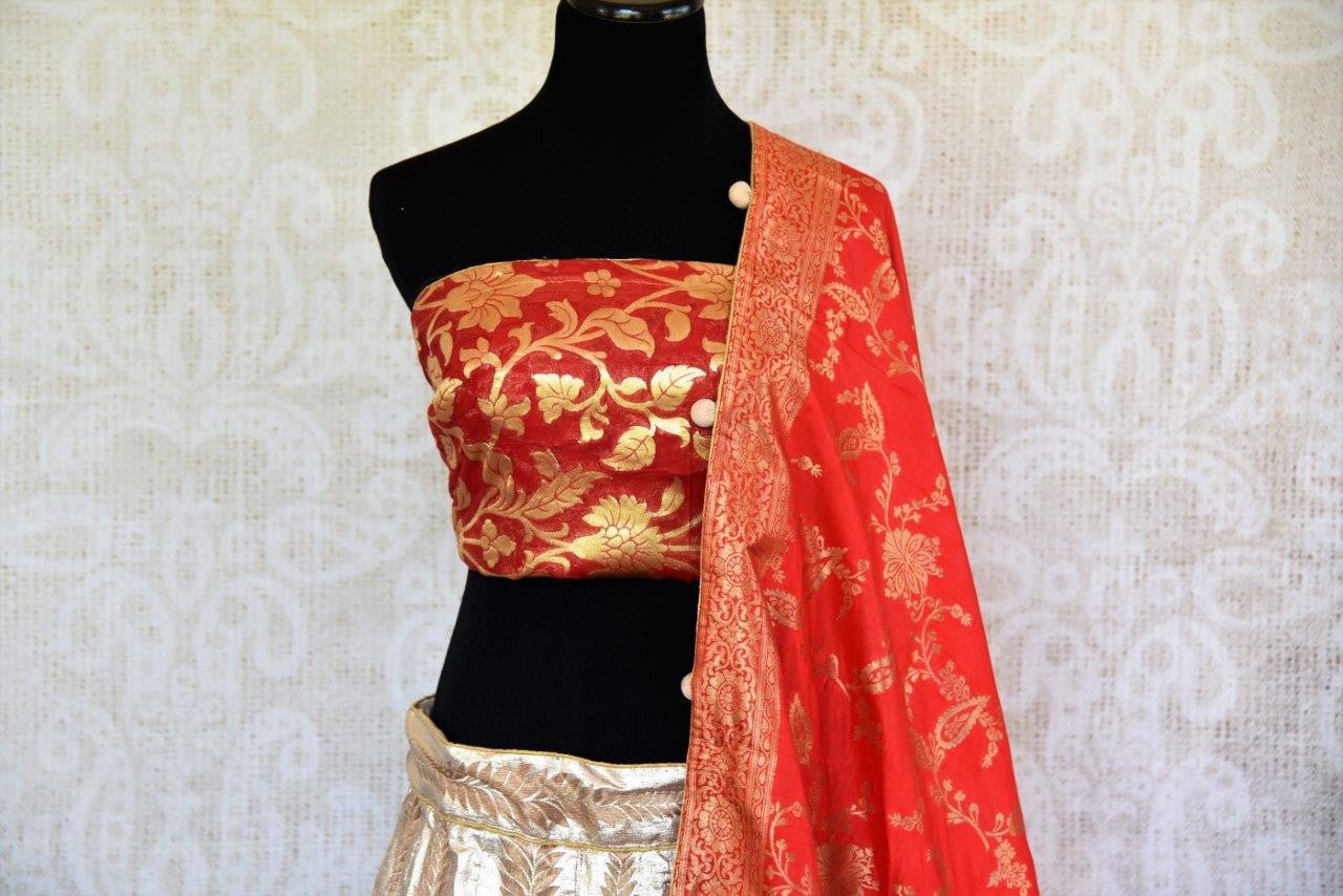 Buy gold Banarasi silk Lehenga with red blouse piece and dupatta online in USA.  Pure Elegance store brings exquisite range of Indian designer lehenga online in USA.-top